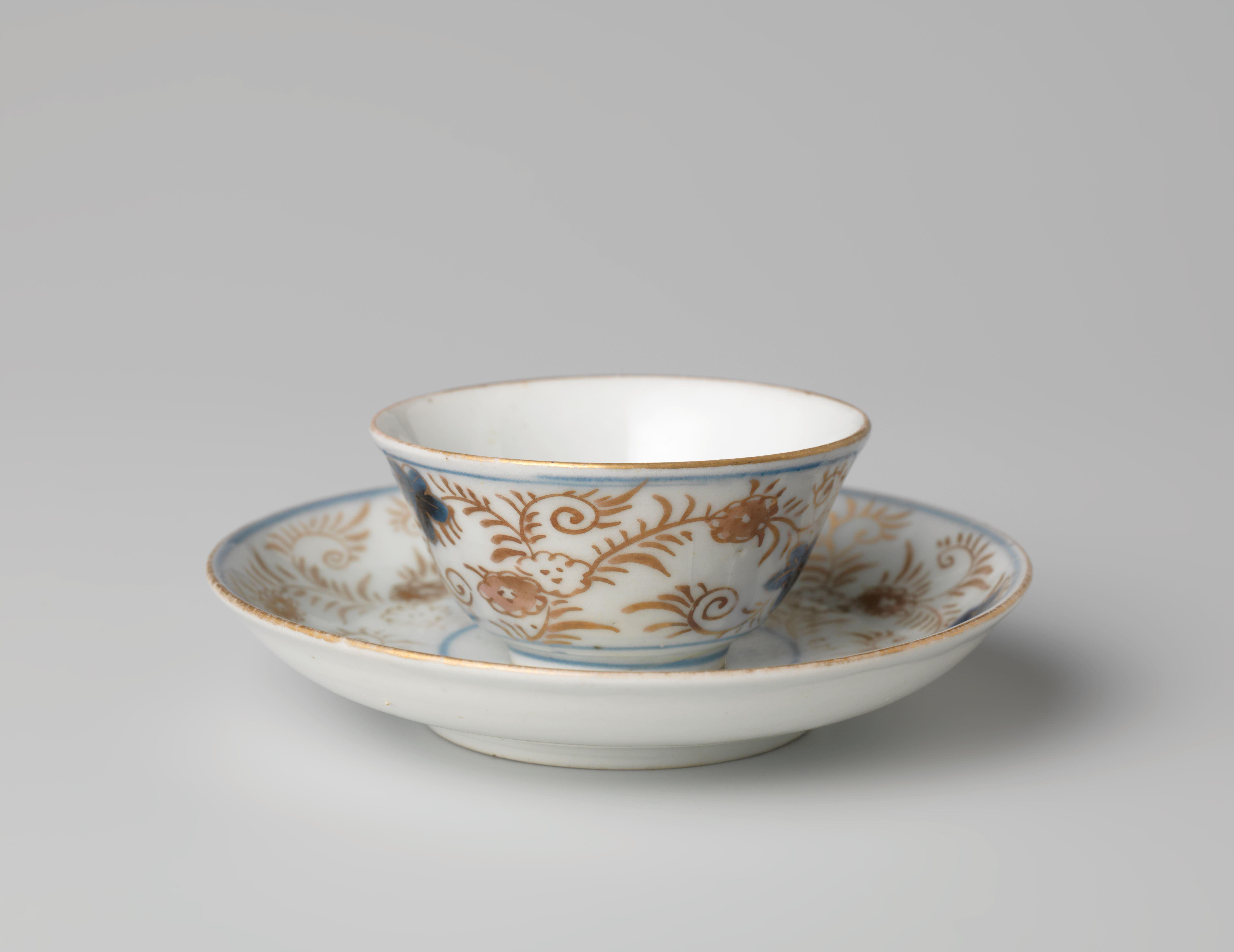 Bell-shaped cup and saucer with a flower basket and floral scrolls