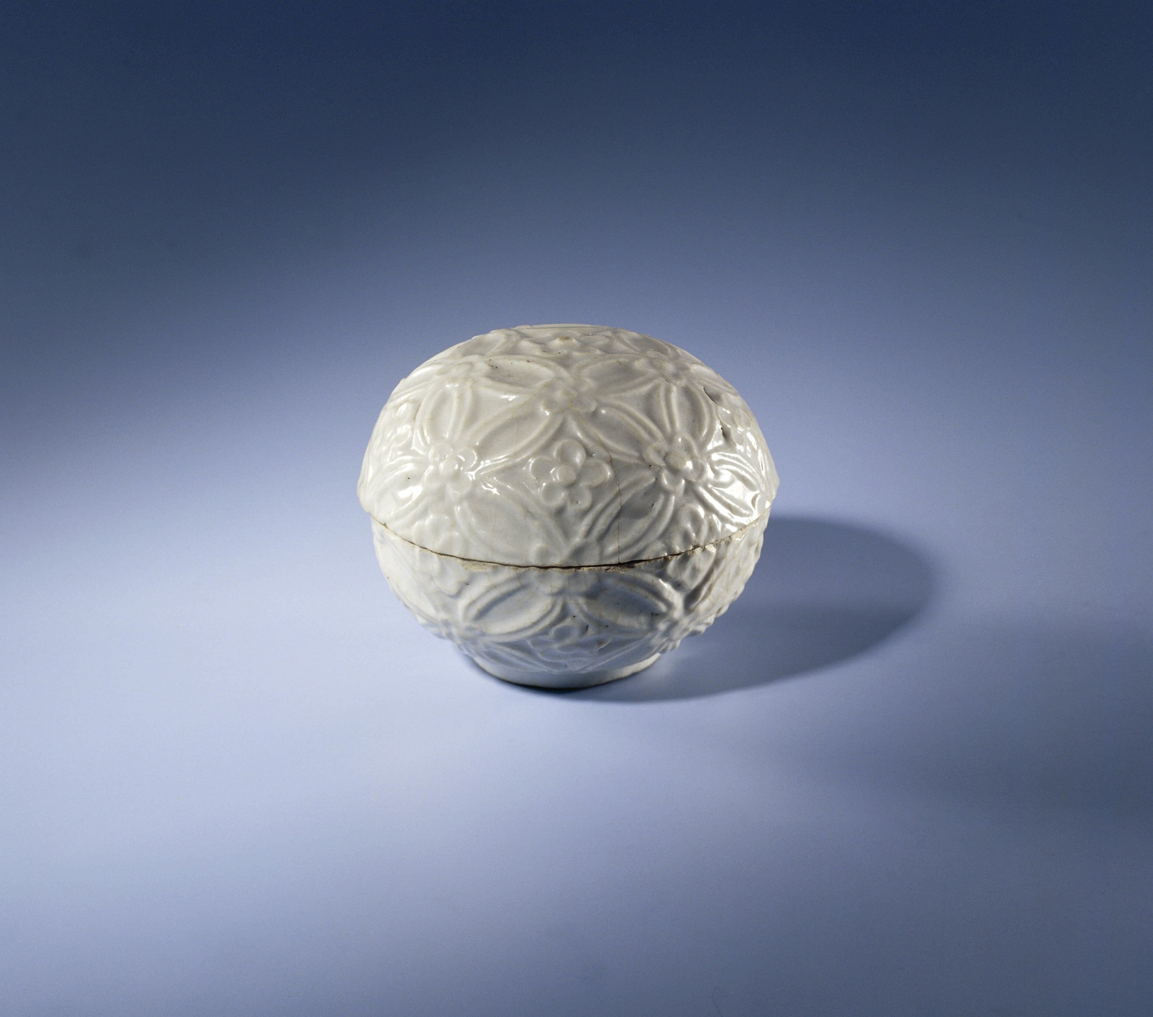 Round-bodied box with continuous flower motif in relief