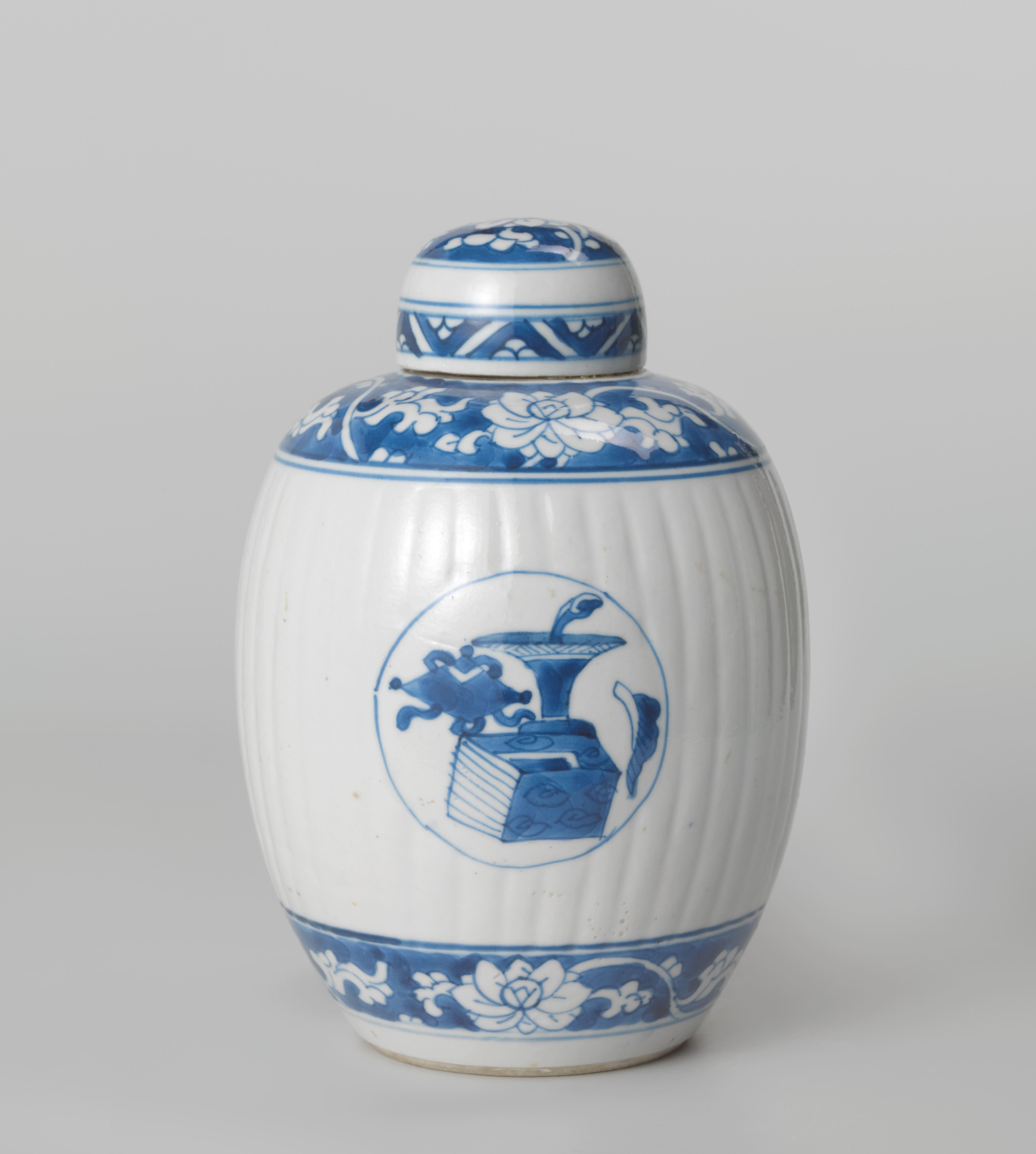 Ovoid fluted covered jar with precious objects in medallions and floral scrolls