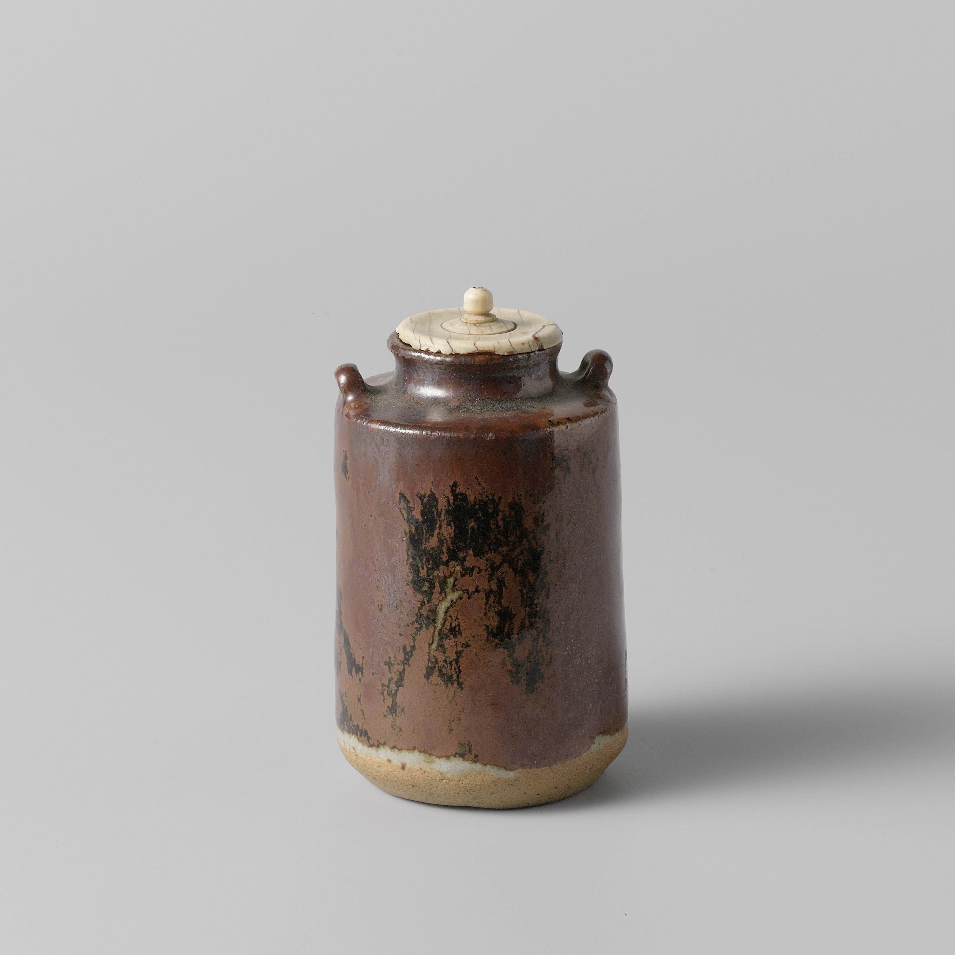 Tea caddy with a brown black glaze and two handles