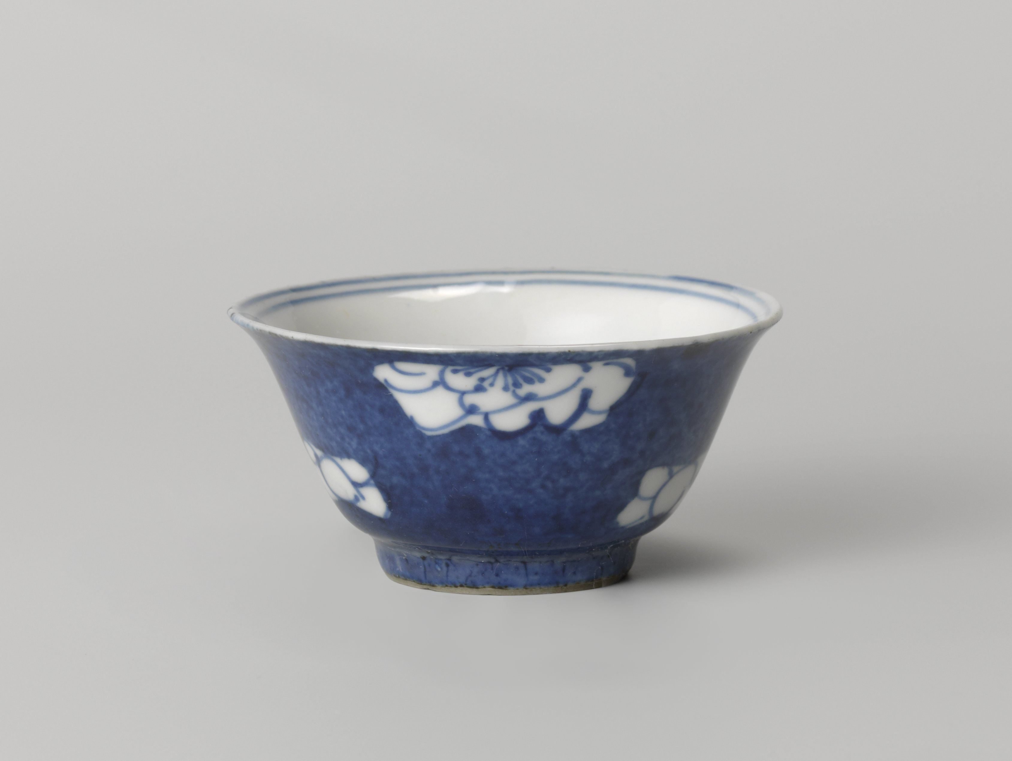 Bell-shaped cup with powder blue and flower heads in reserve