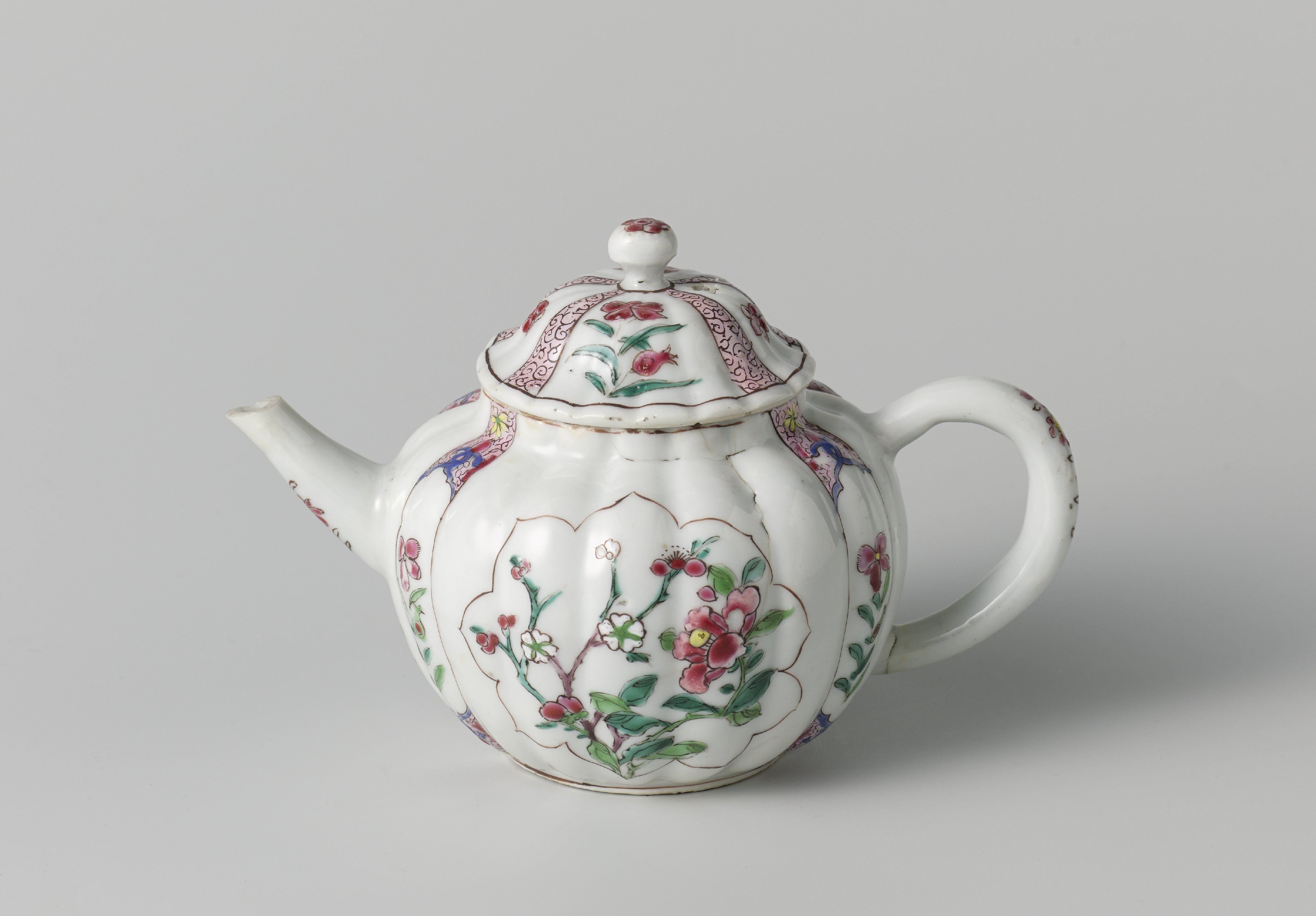 Fluted tea pot with flower sprays in panels