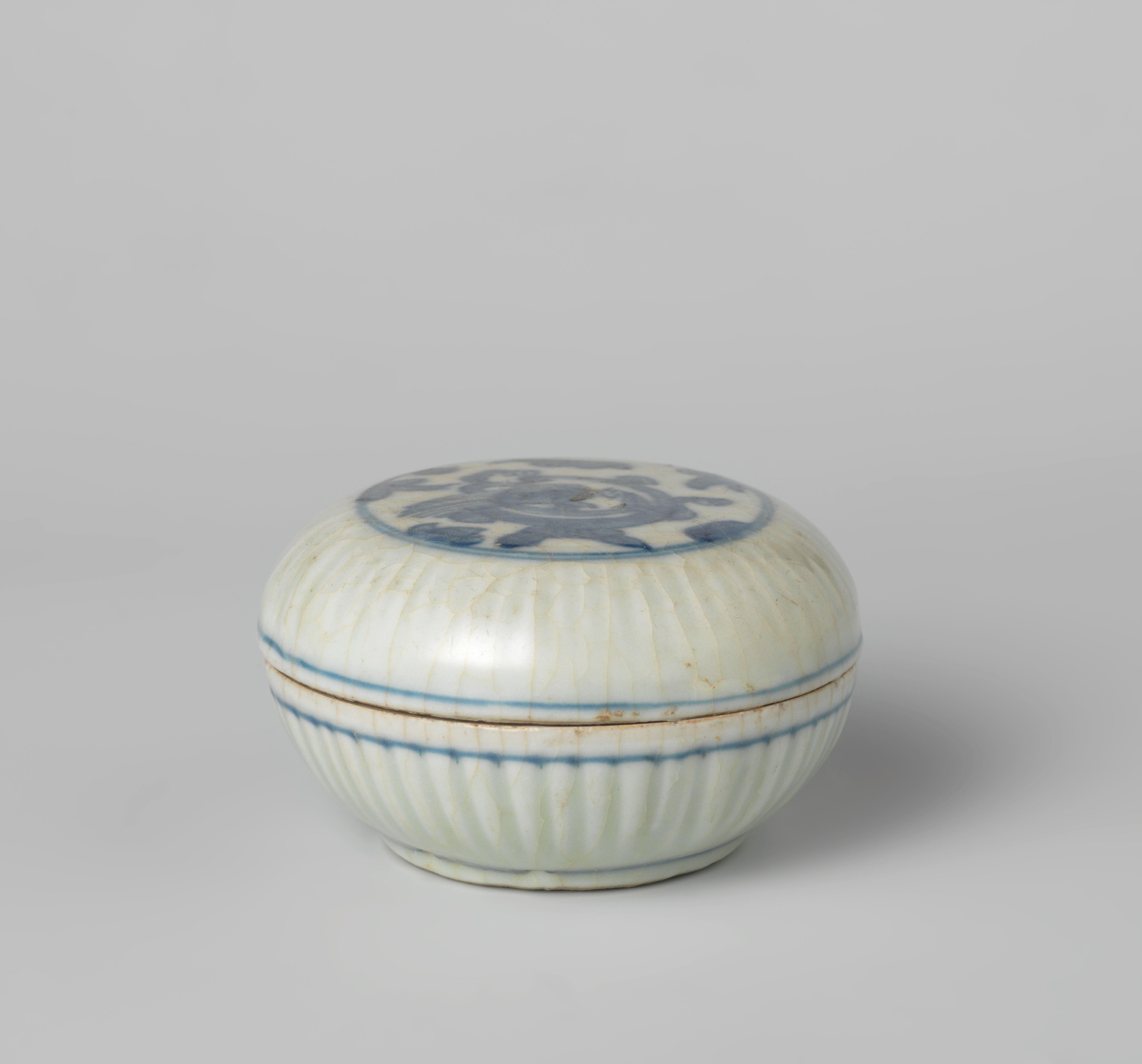 Round box with ribbed sides and a coiling dragon in a medallion on the cover