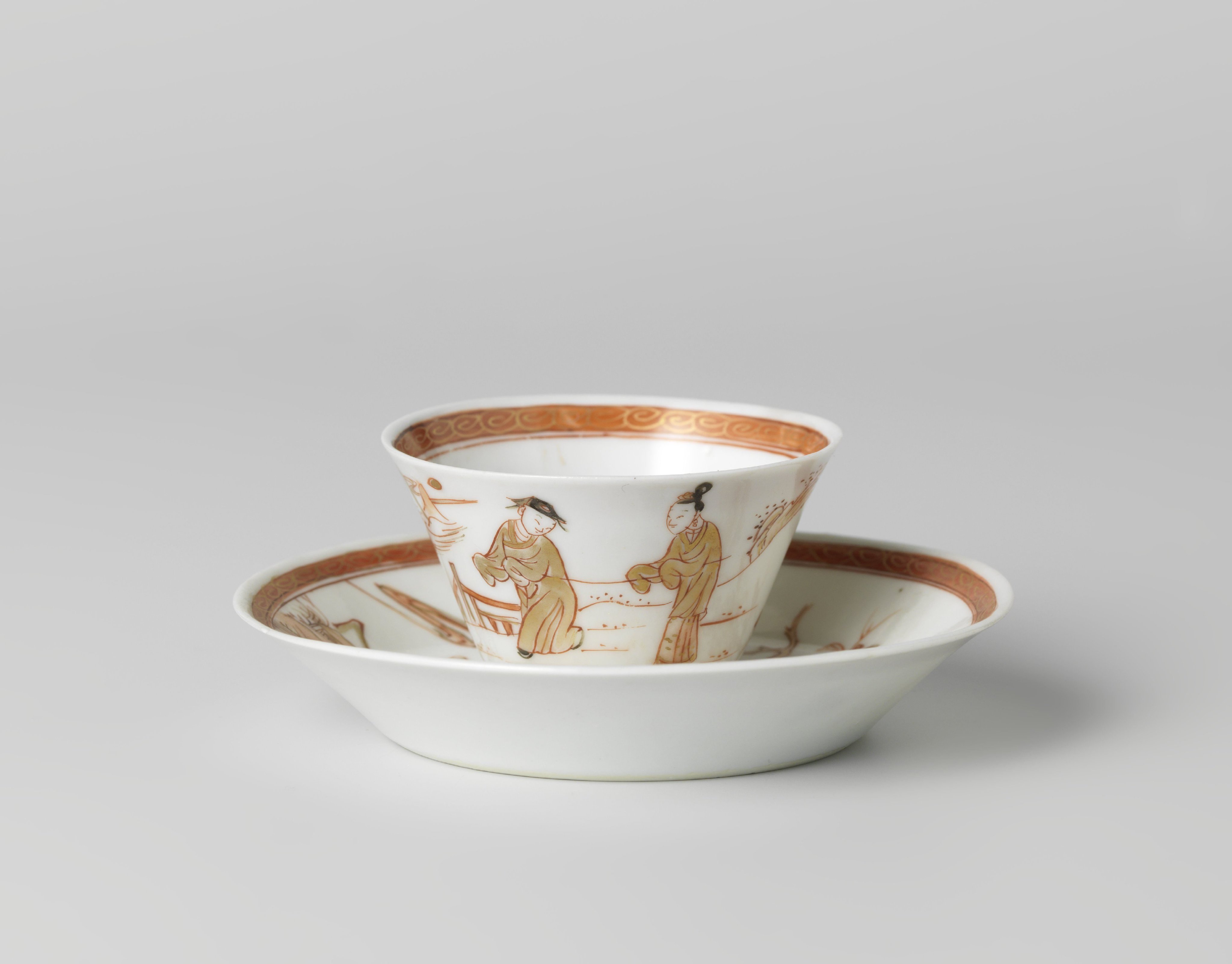 Cup and saucer with two figures in a water landscape and a flowering tree