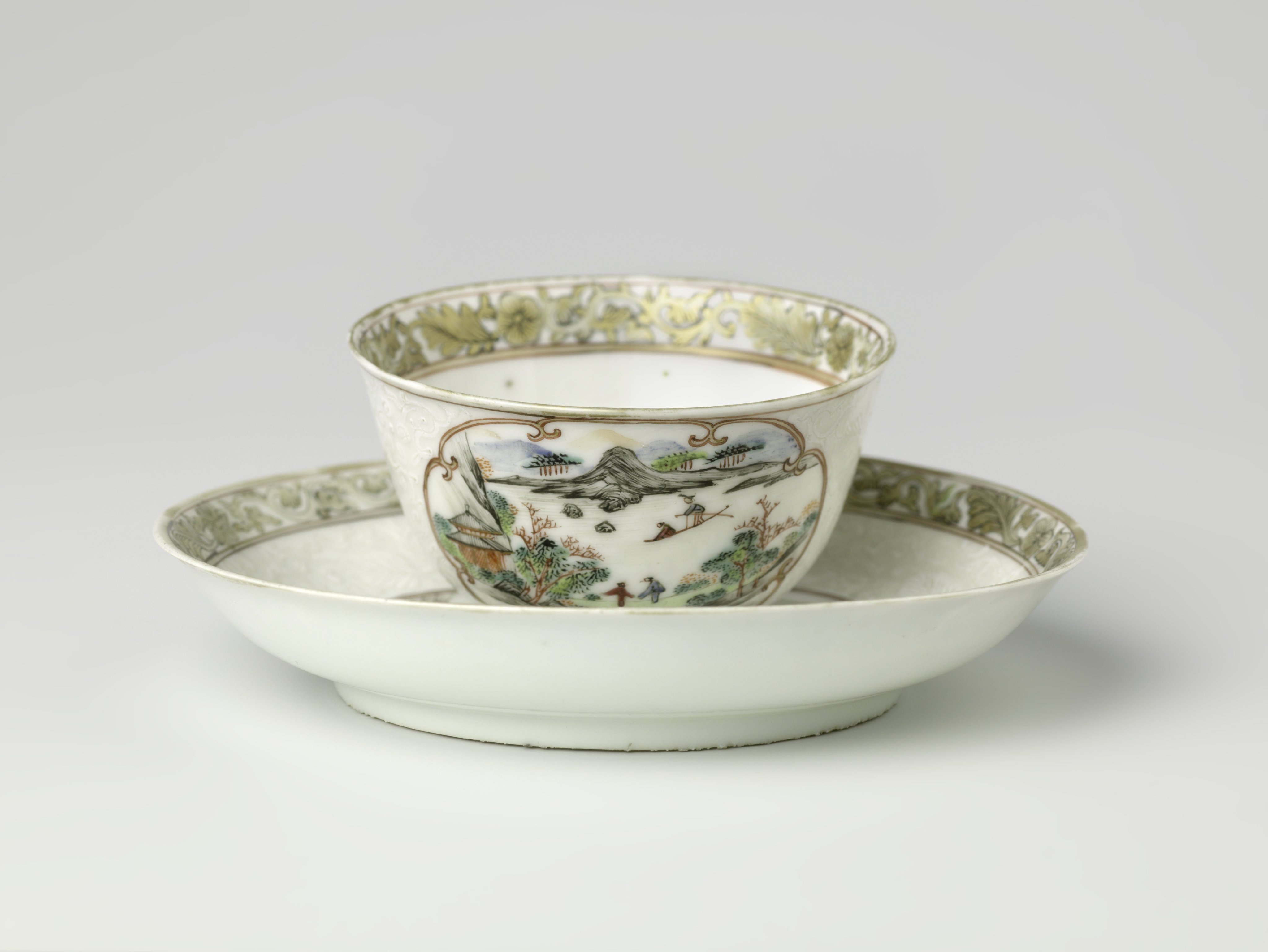 Bell-shaped cup and saucer with a water landscape and floral scrolls