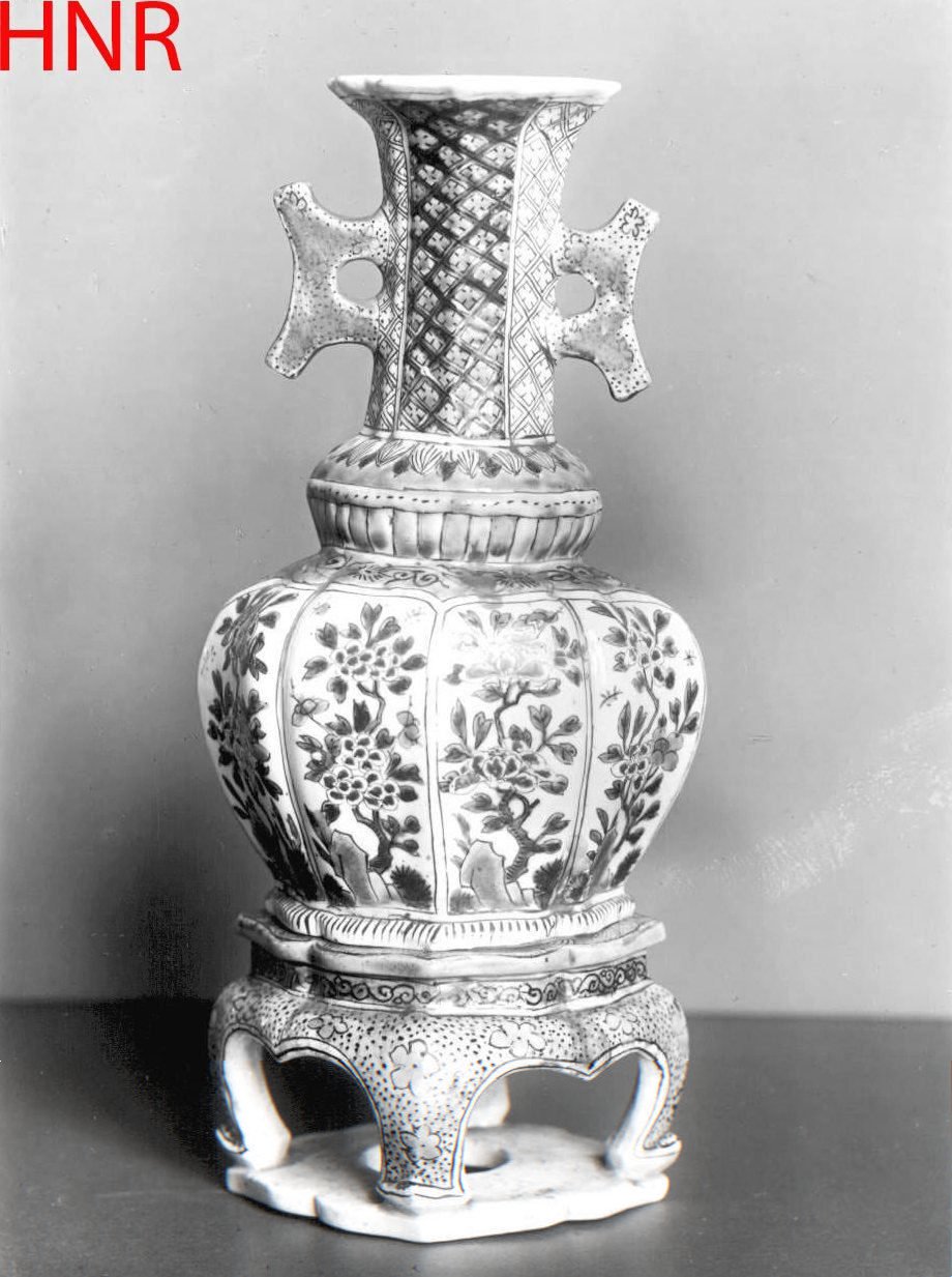 Octagonal vase with two handles, flowering plants and diaper pattern on a seperate stand