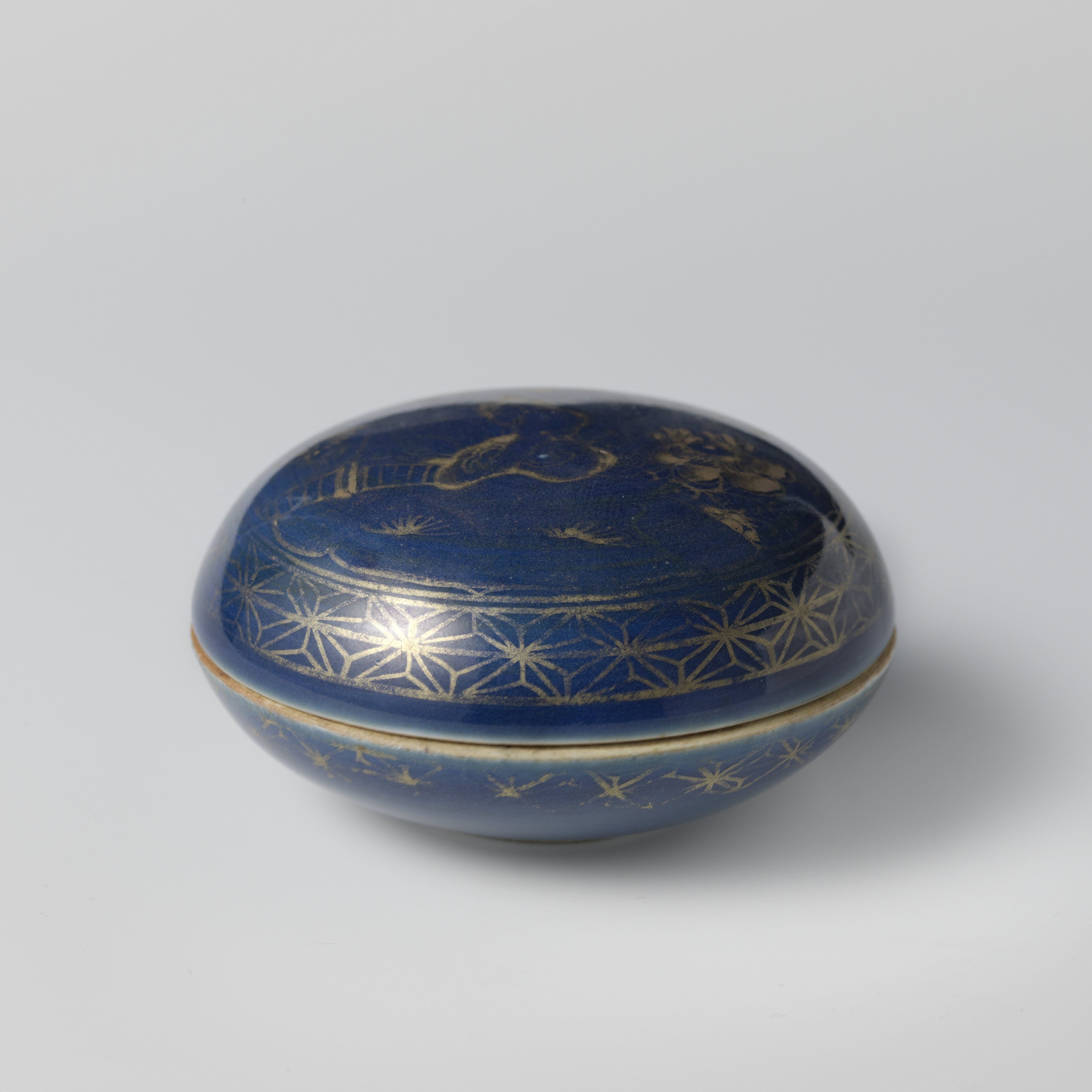 Round box with powder blue, rocks and flowering plants