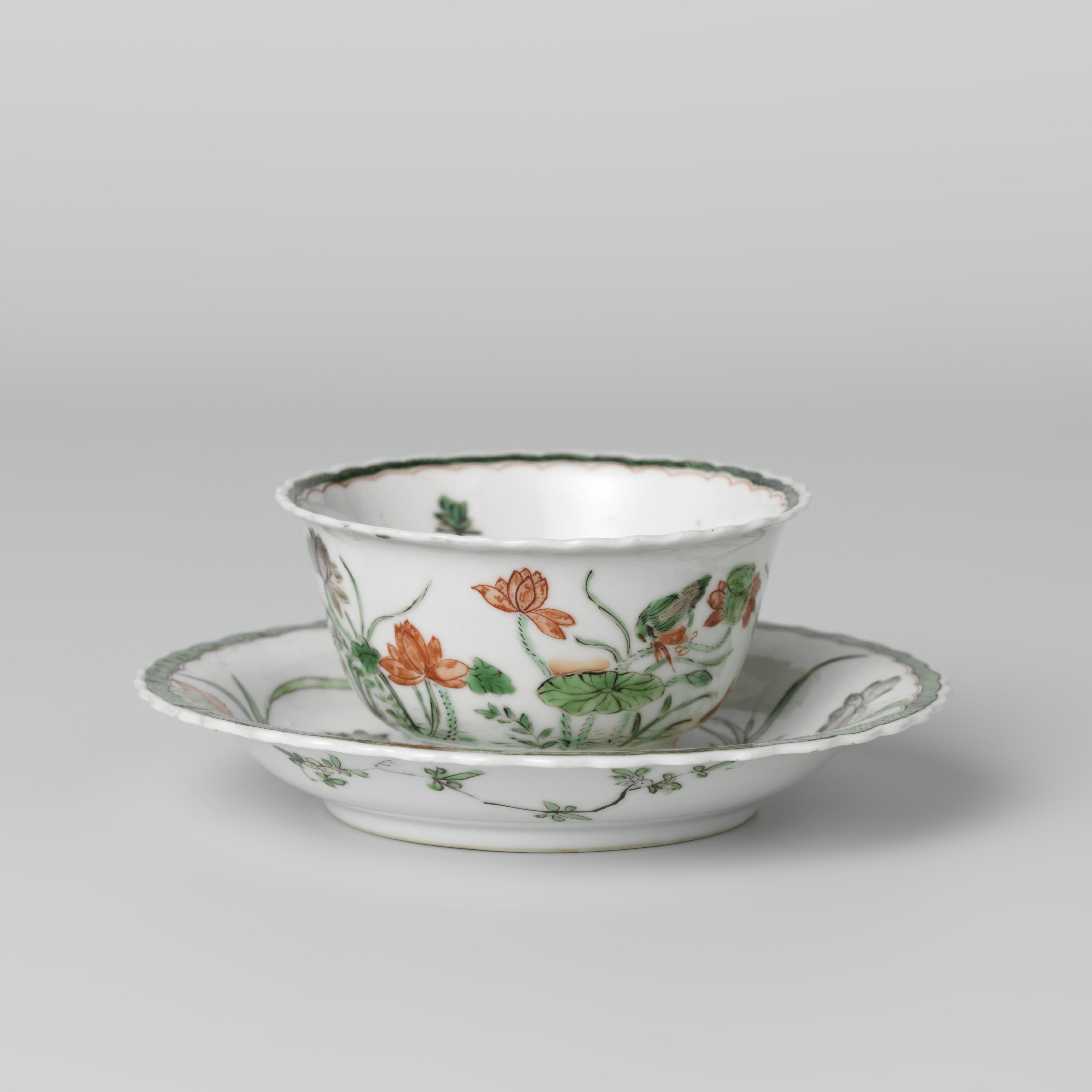 Cup and saucer with a pond, lotus plants, fish and birds
