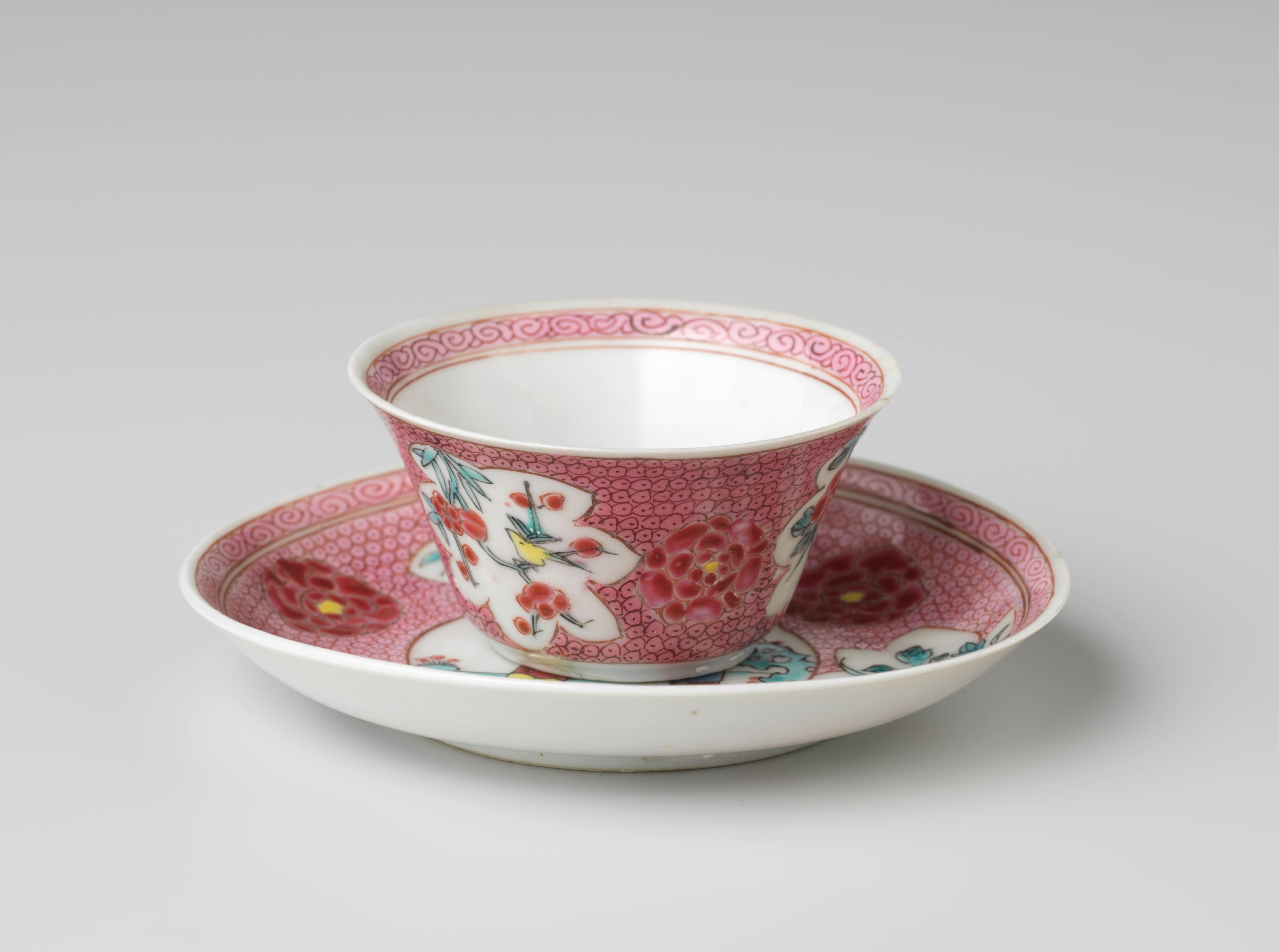 Cup and saucer with a woman and boy in a landscape and flower sprays on diaper-pattern