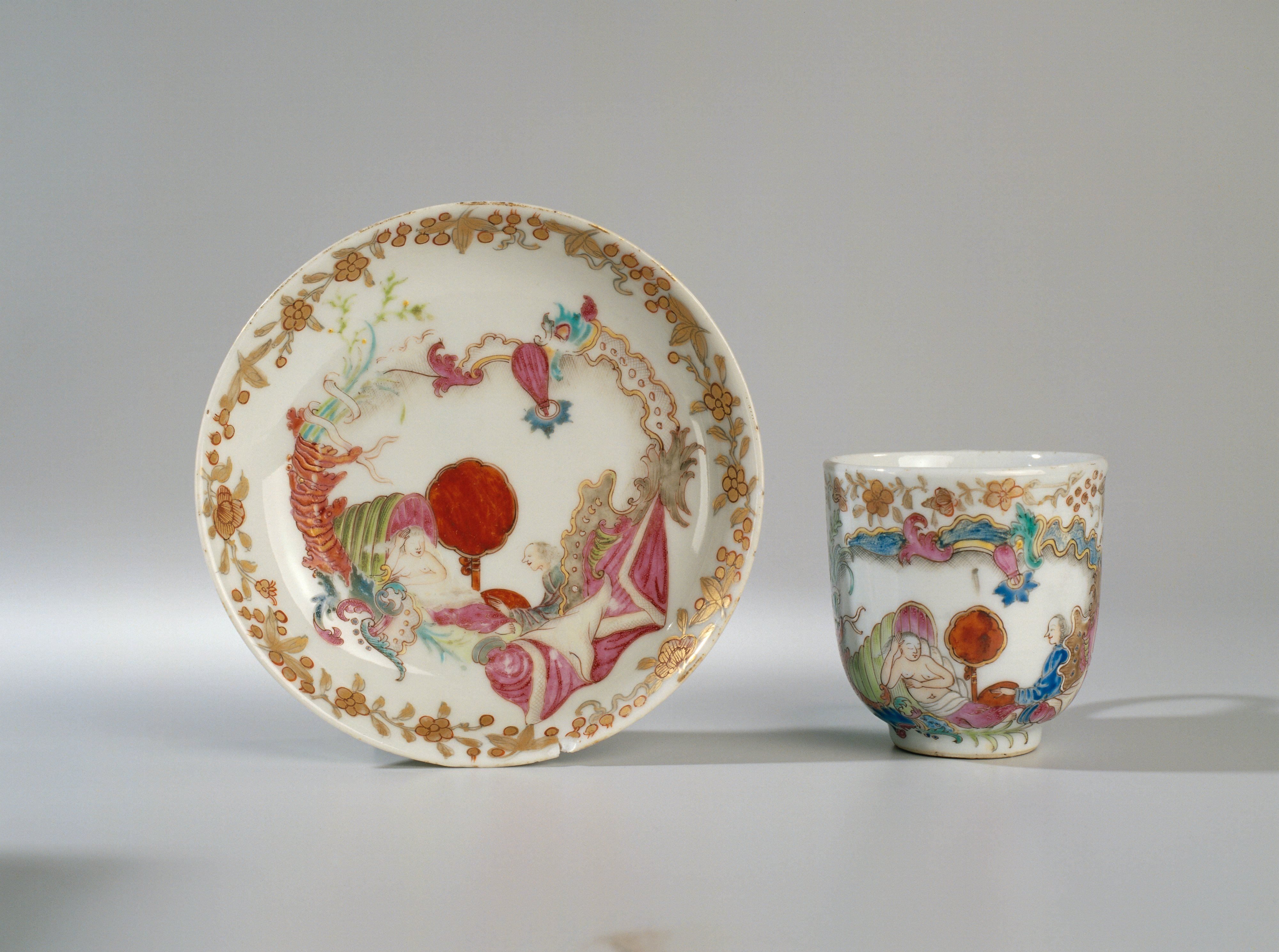 Bell-shaped cup and saucer with an erotic scene