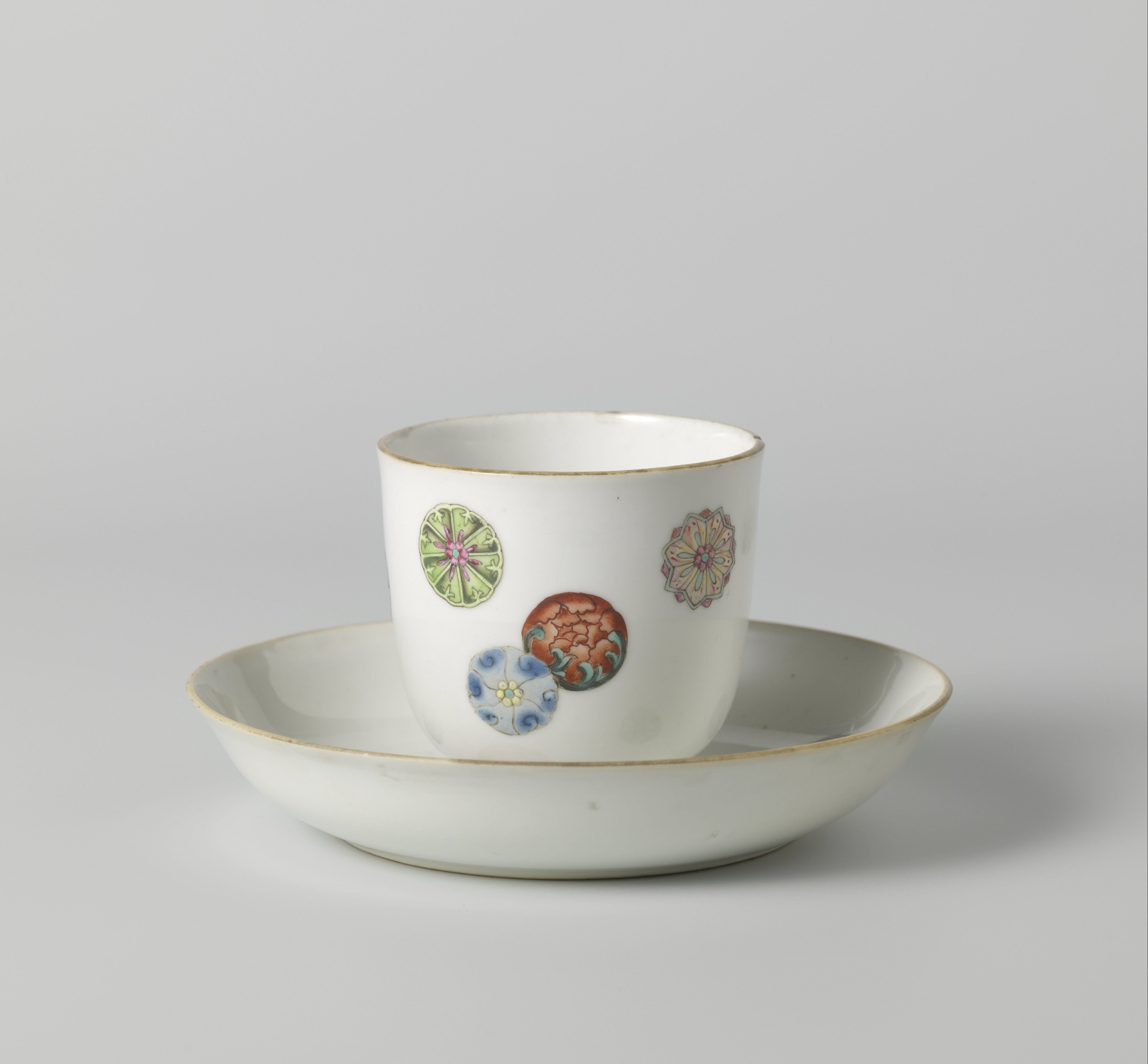 Straight-sided cup and saucer with scattered stylised flowers