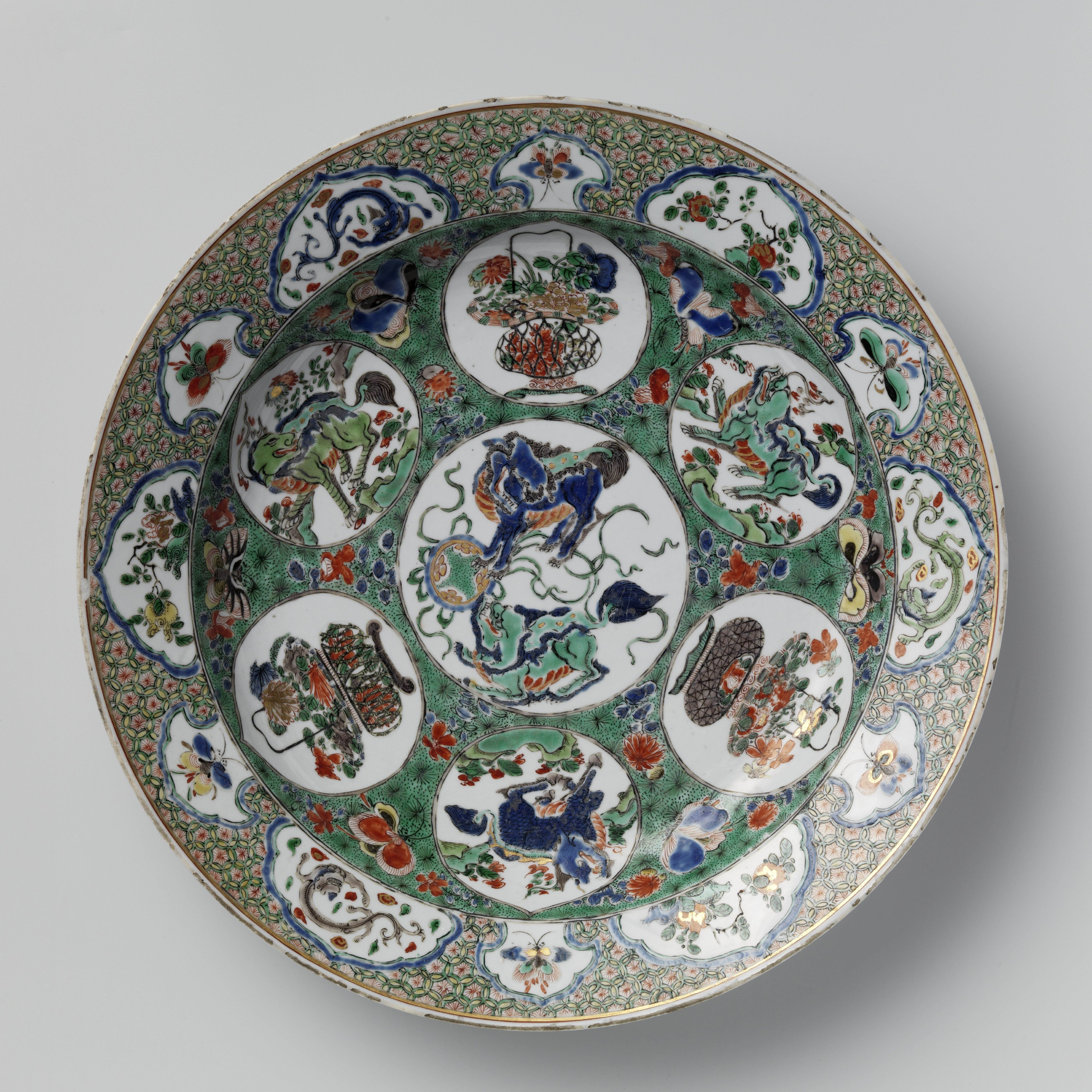 Dish with (mythological) animals, flower baskets and flowering plants