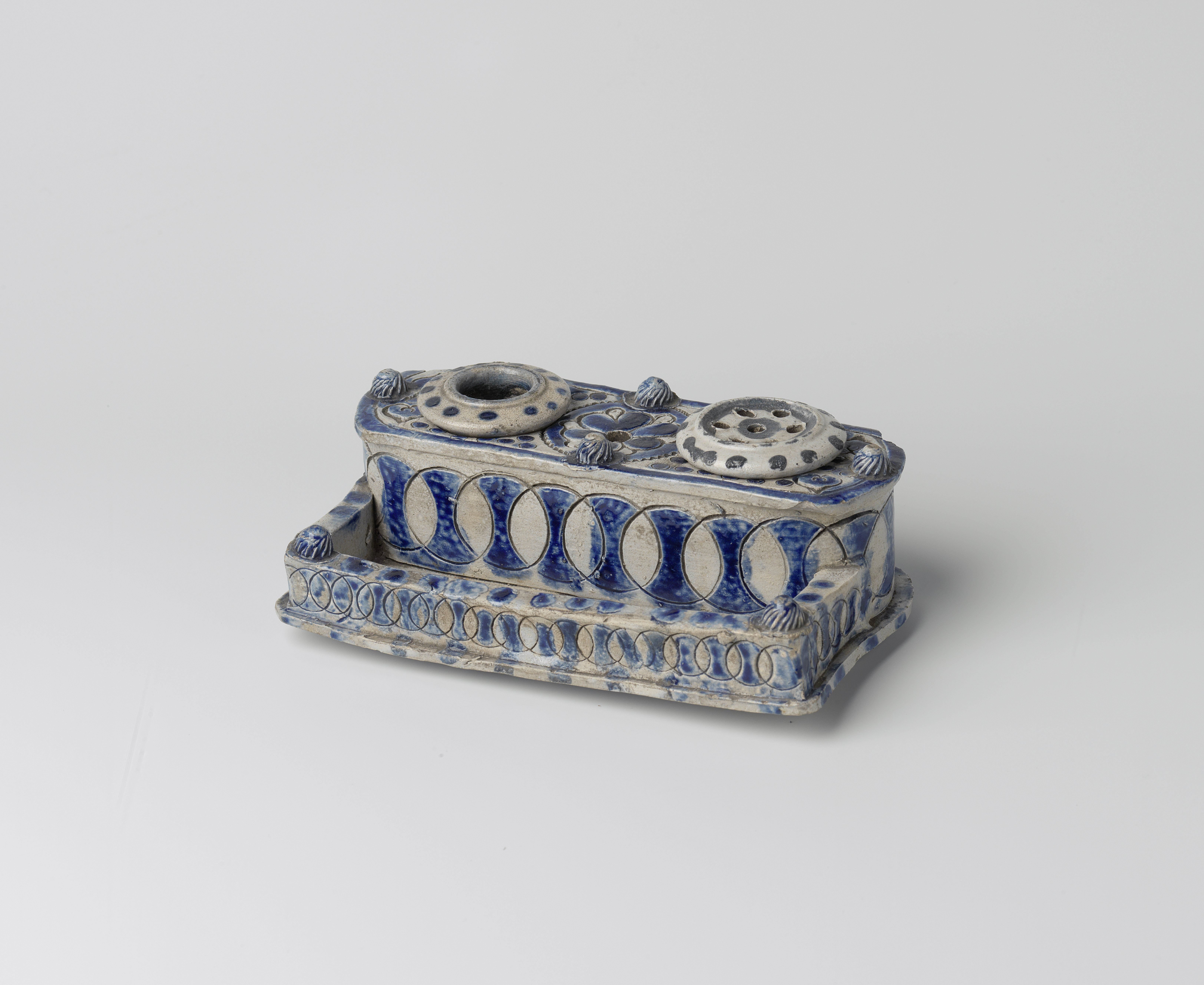 Ink stand with circles and a flower roundel