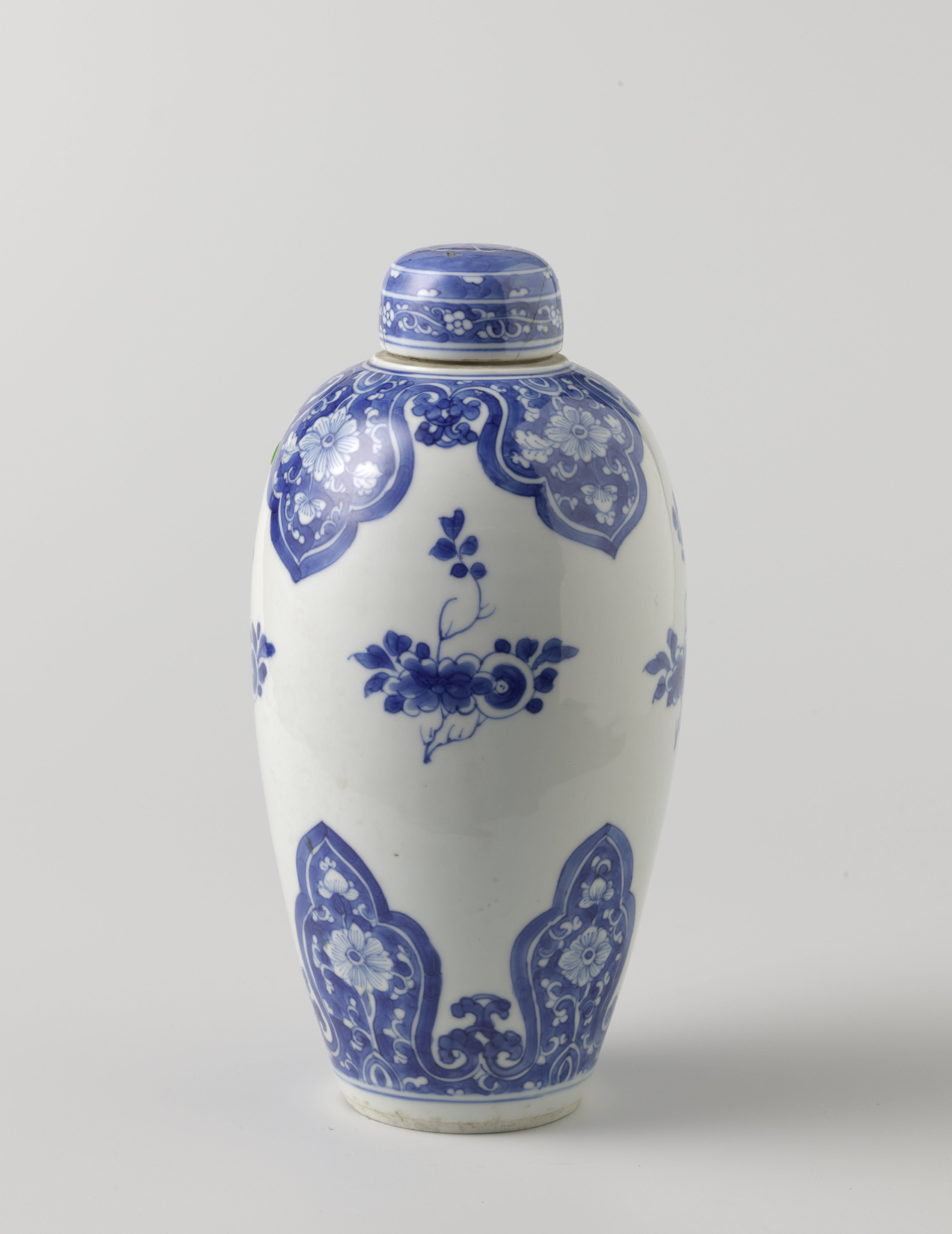 Ovoid covered jar with flower scrolls in lappet borders