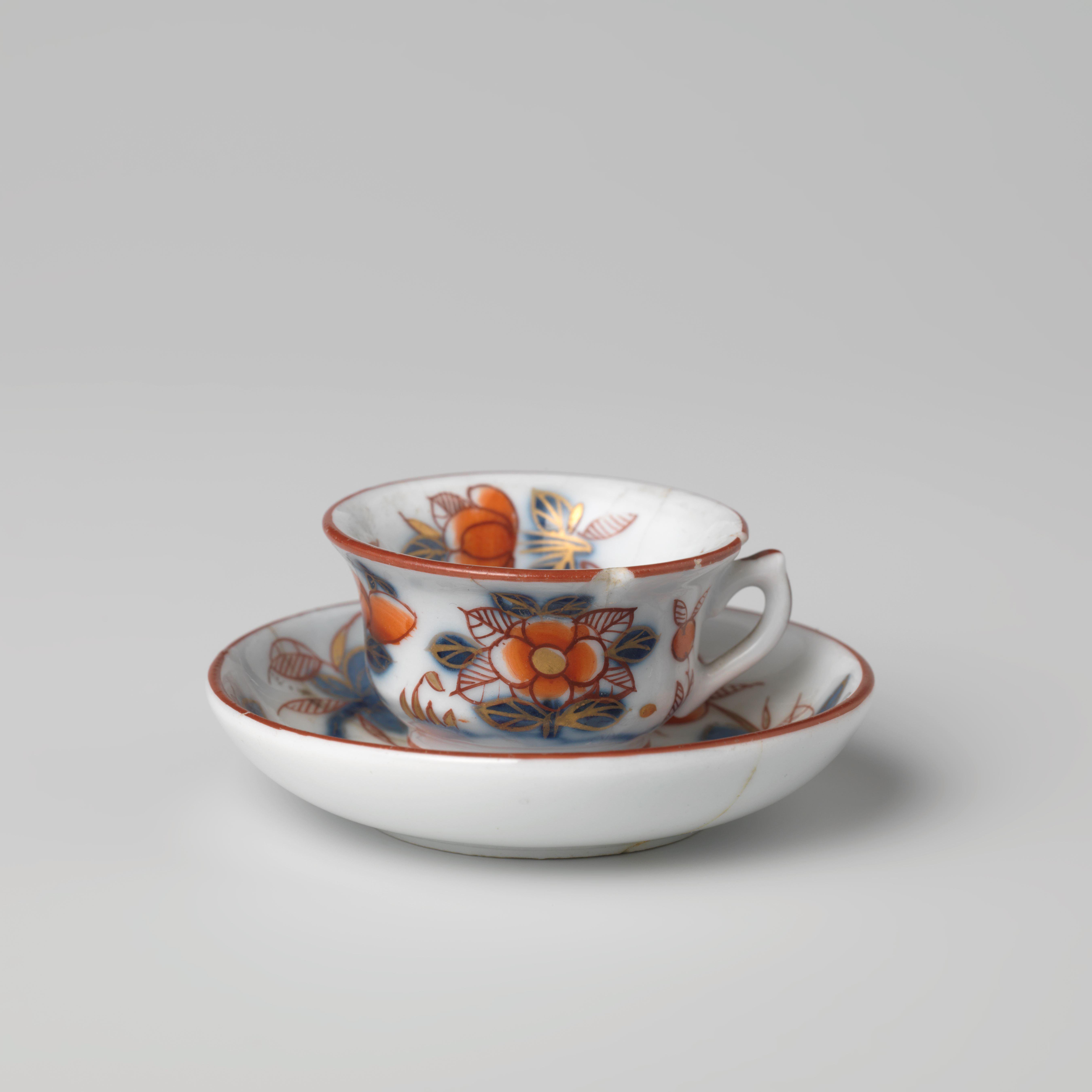 Miniature bell-shaped cup with handle and saucer with flowering plants