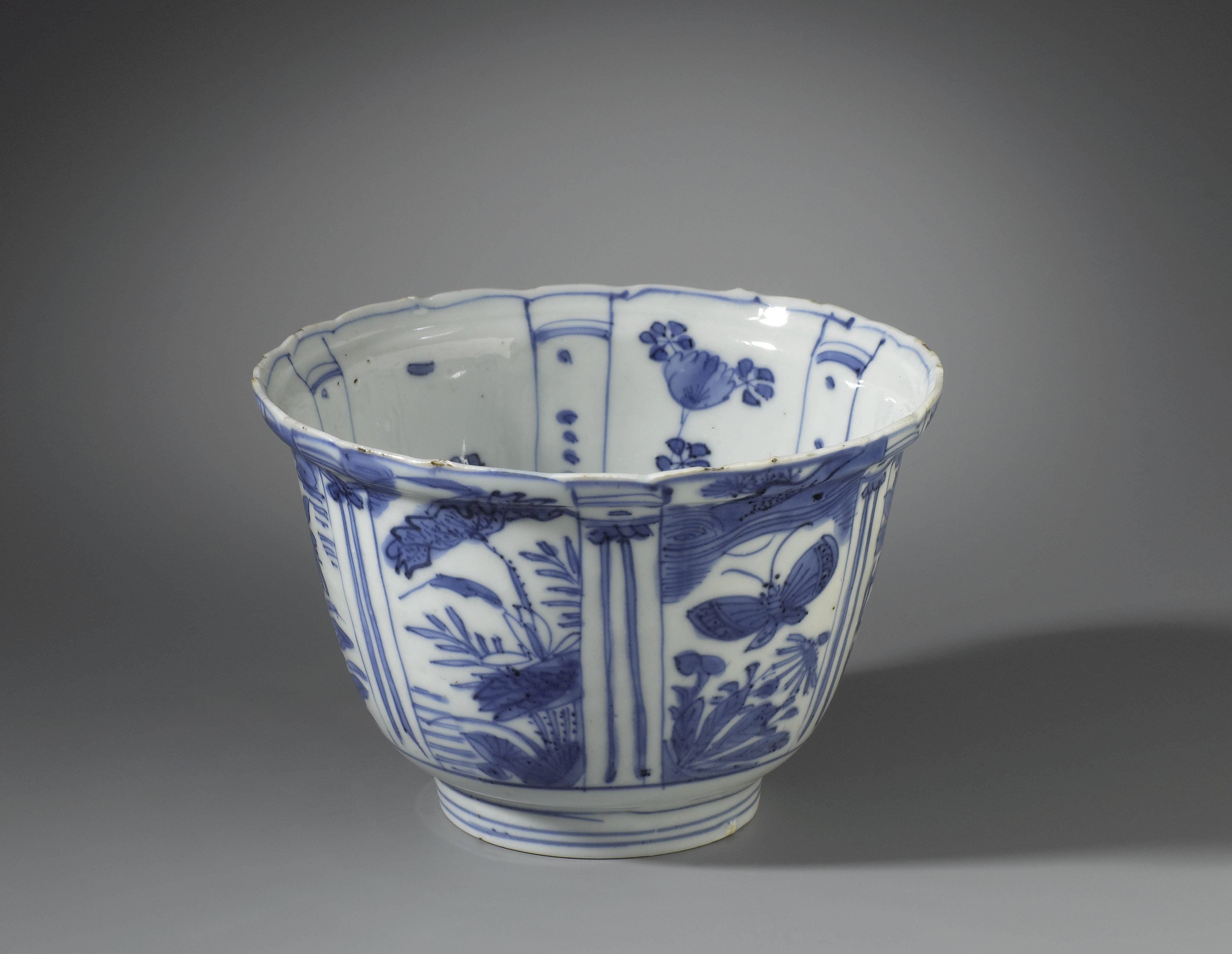 Bowl (crow cup) with flowering plants, flying birds and a bird on a rock
