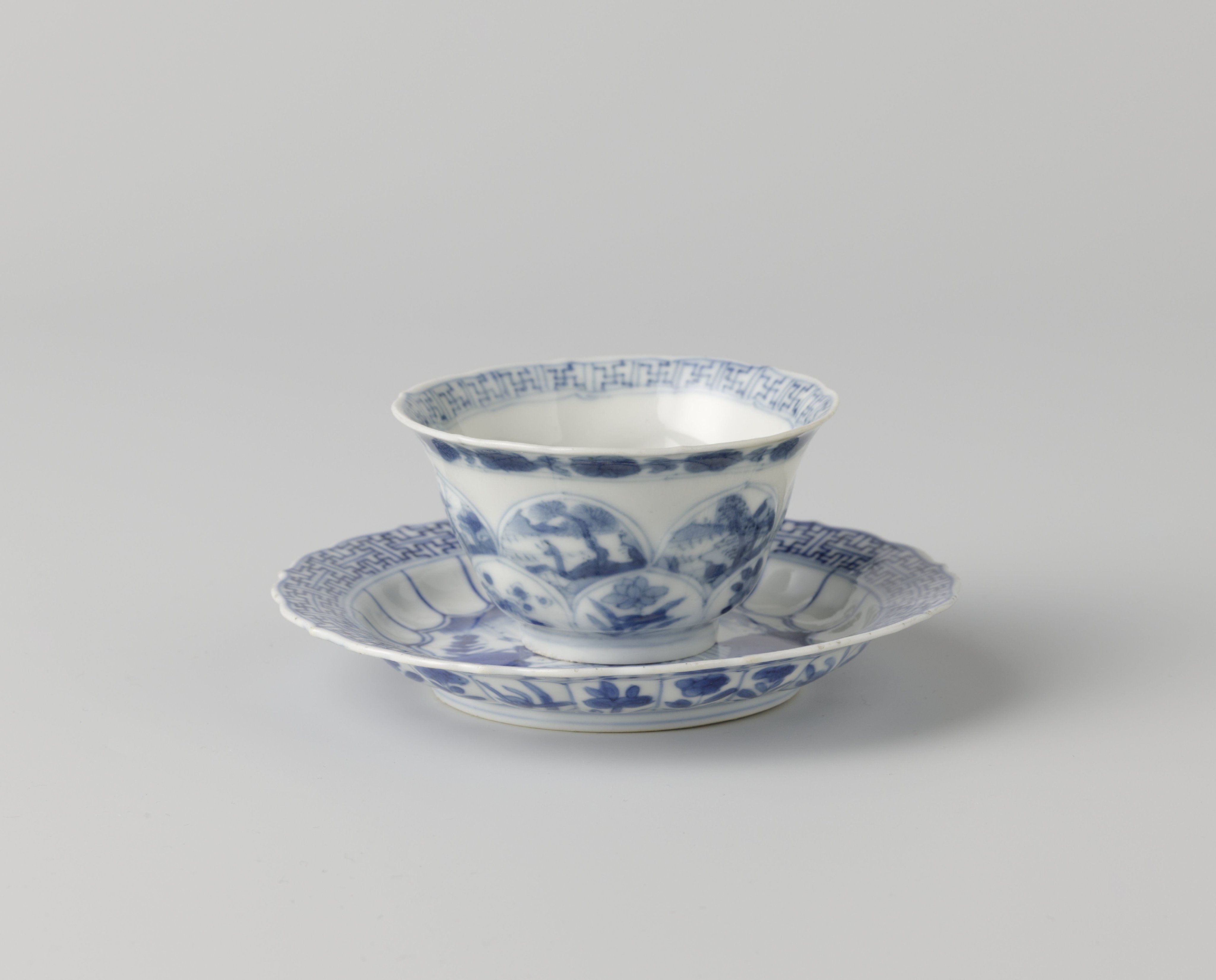 Cup and saucer with with an erotic scene and flower sprays