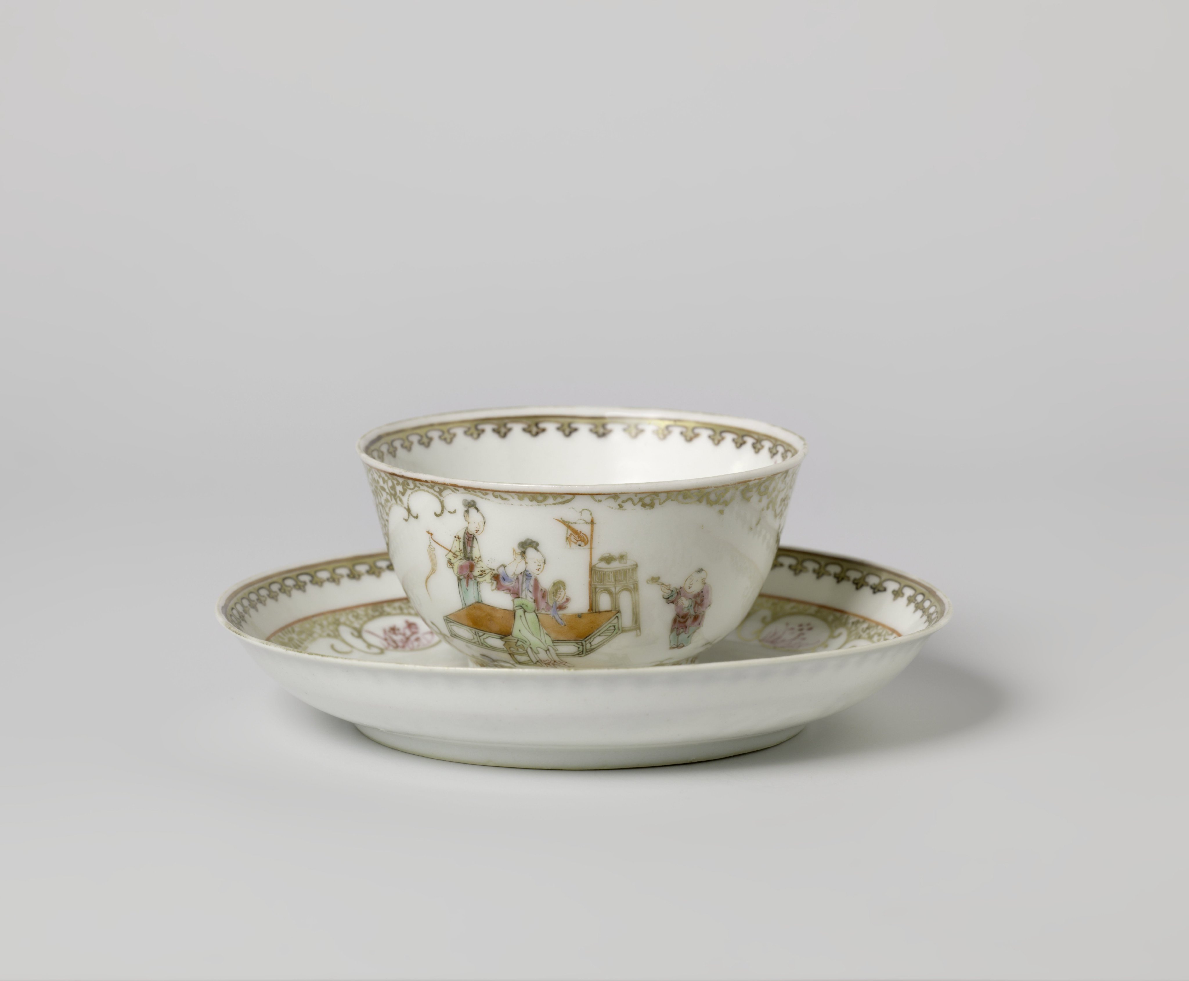 Bell-shaped cup and saucer with women, playing boys and floral scrolls