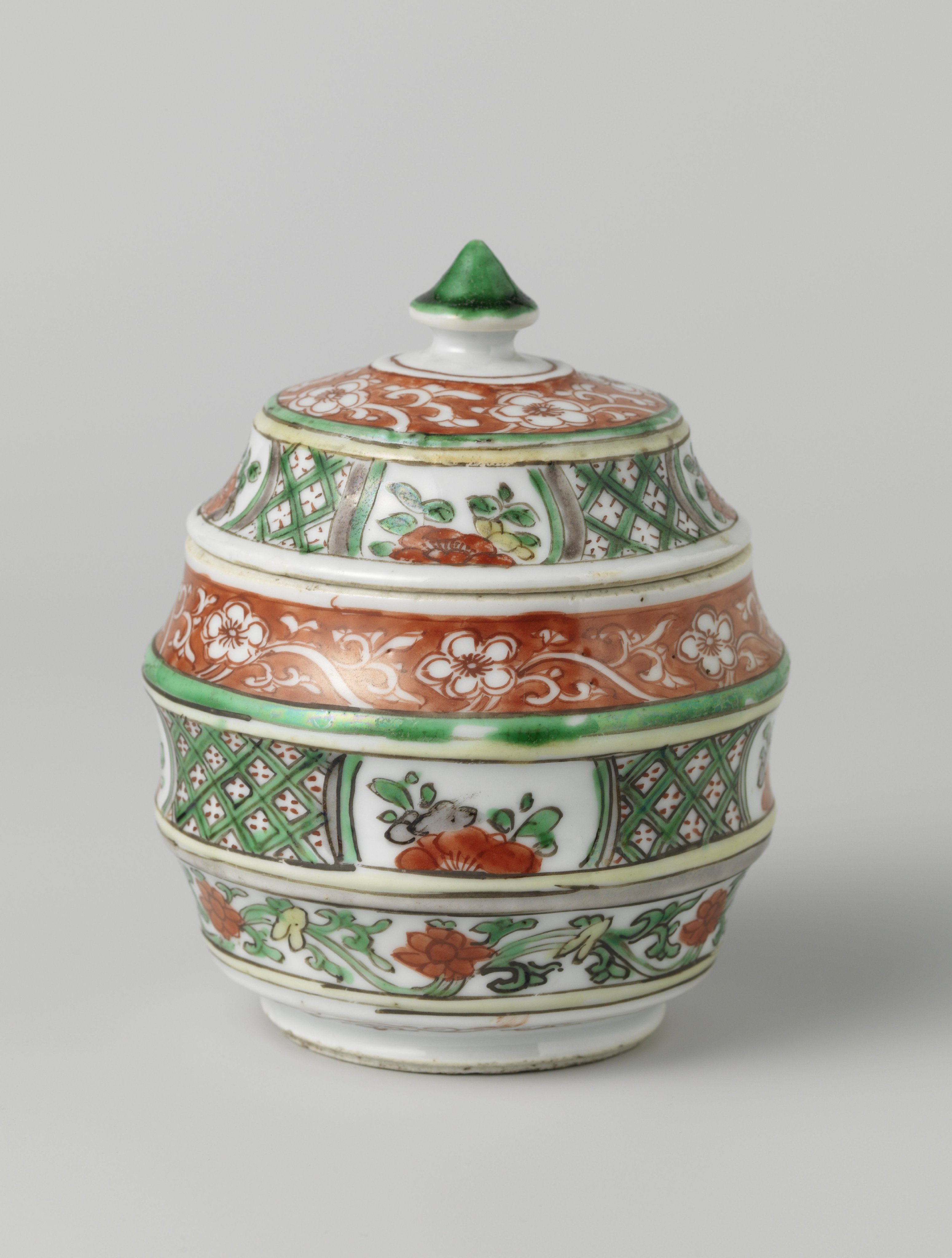 Barrel-shaped covered jar with flower scrolls and geometric patterns