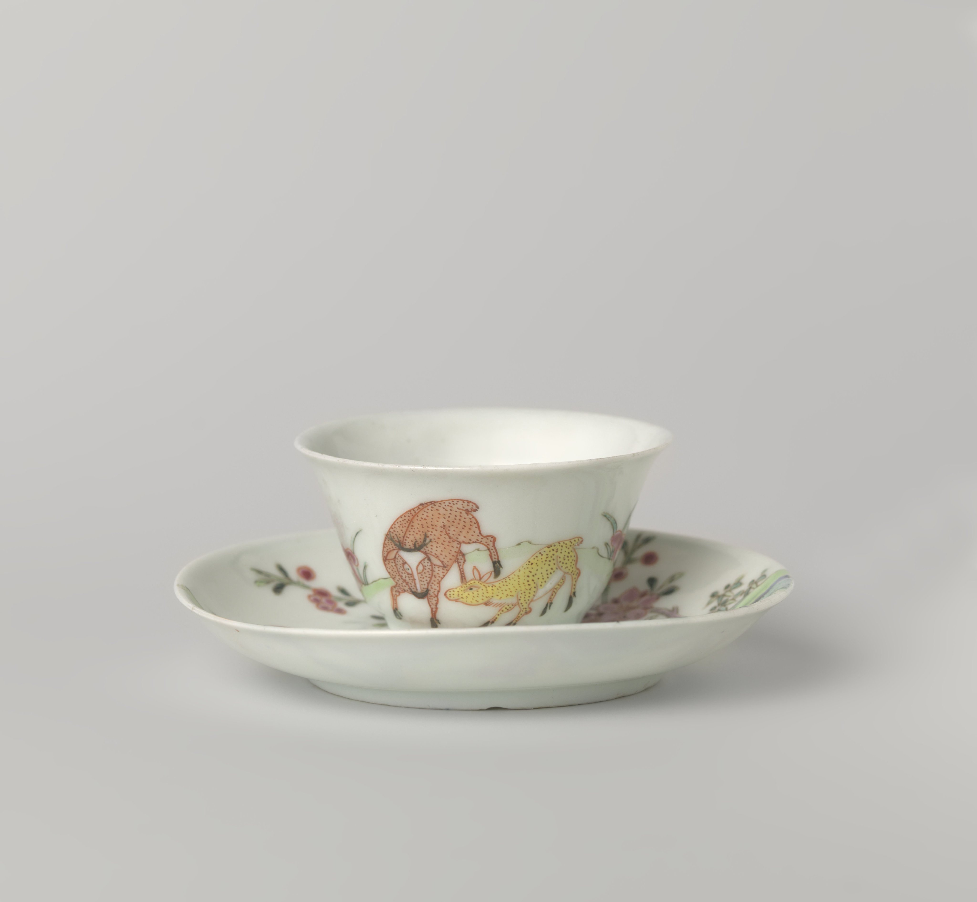 Bell-shaped cup and saucer with two deer in a landscape