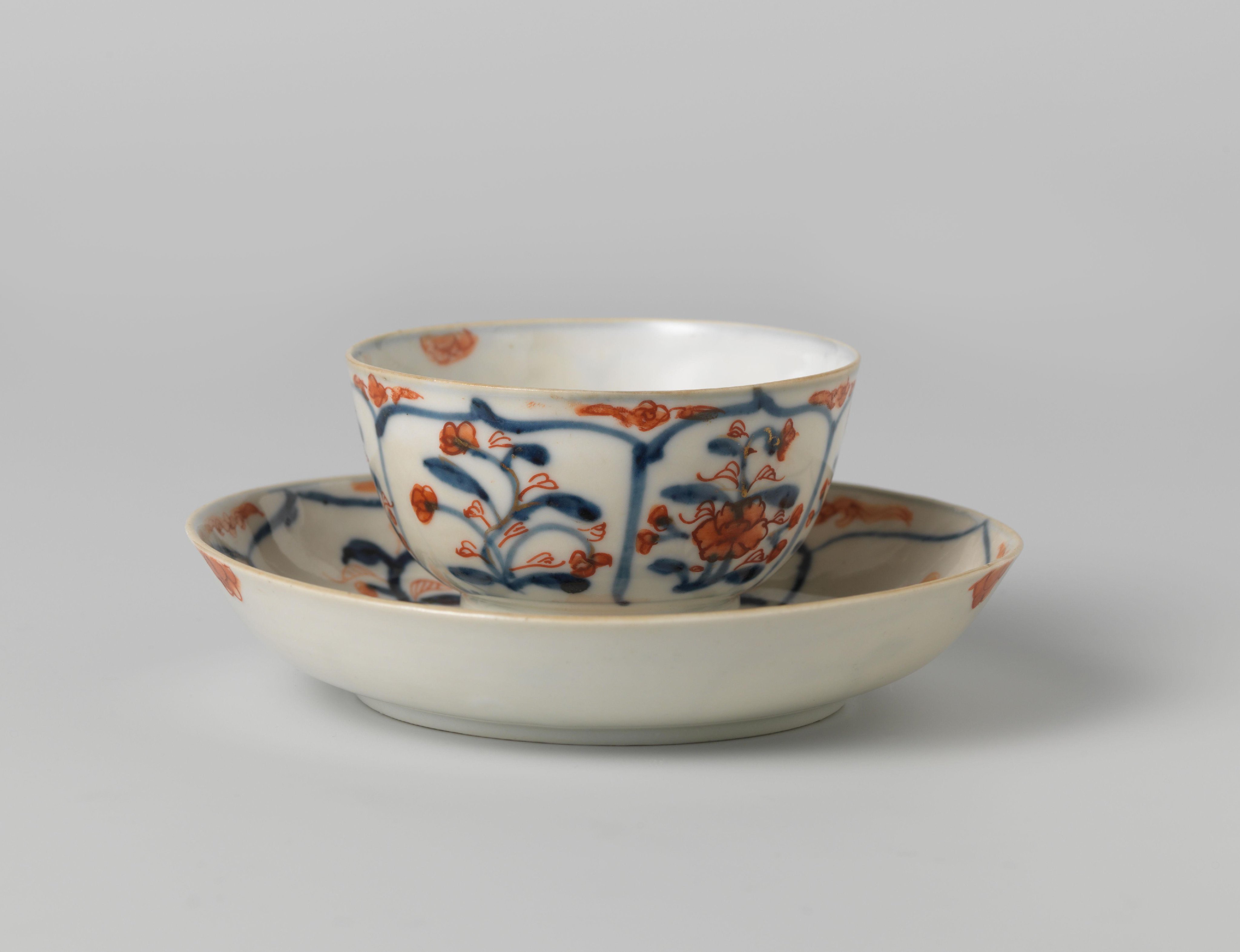 Cup and saucer with petal-shaped panel around a central medallion, filled with flower sprays