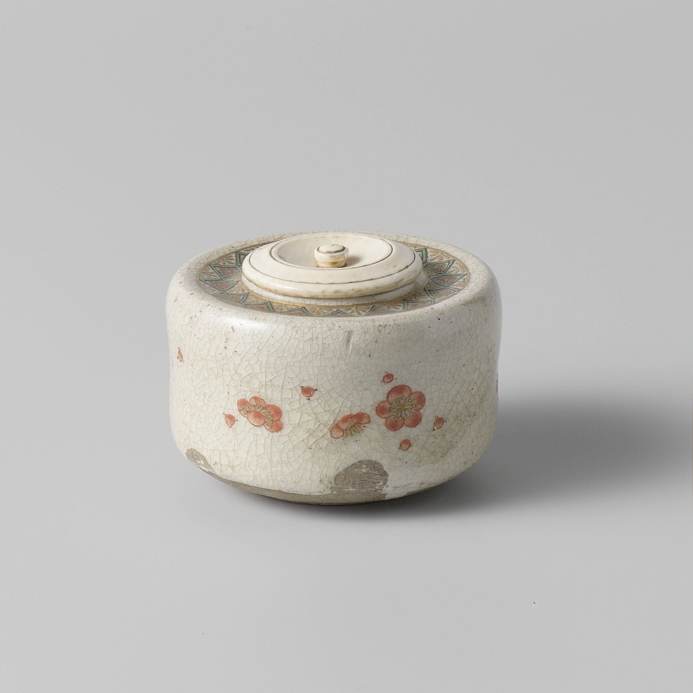 Tea caddy with prunus blossoms and an ornamental border