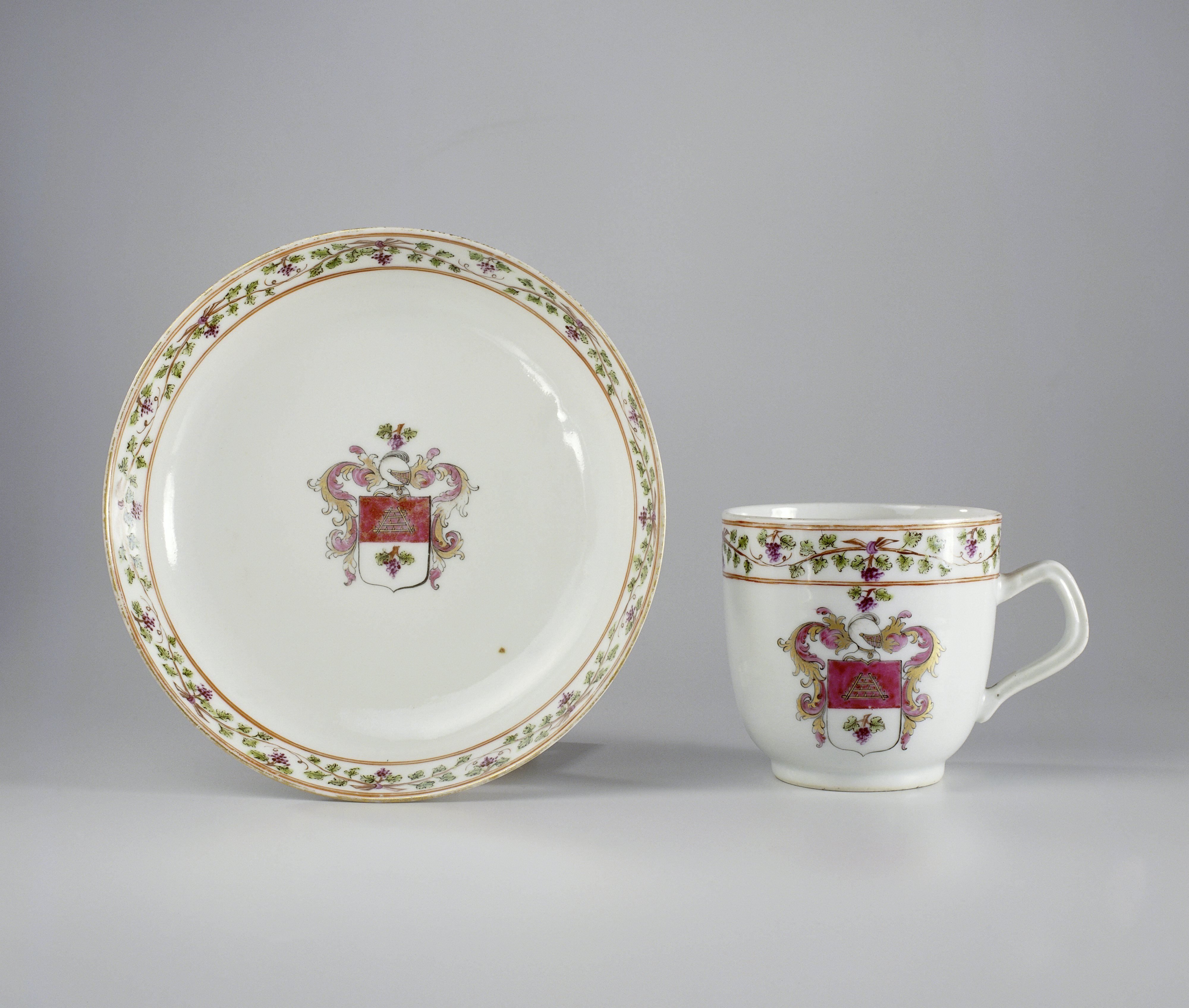 Cup with handle and saucer with a coat of arms and a monogram