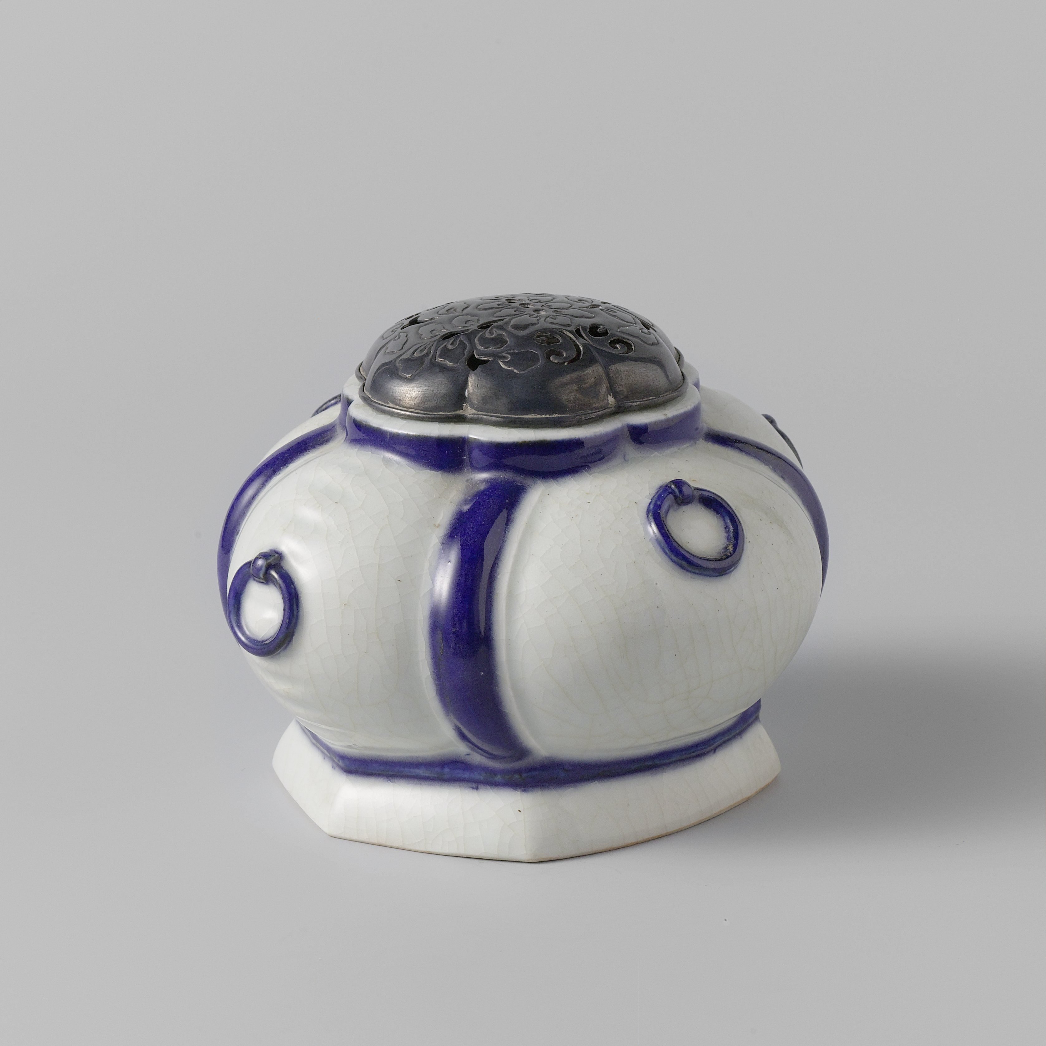 Insence burner with lobed sides, moulded rings and a metal cover