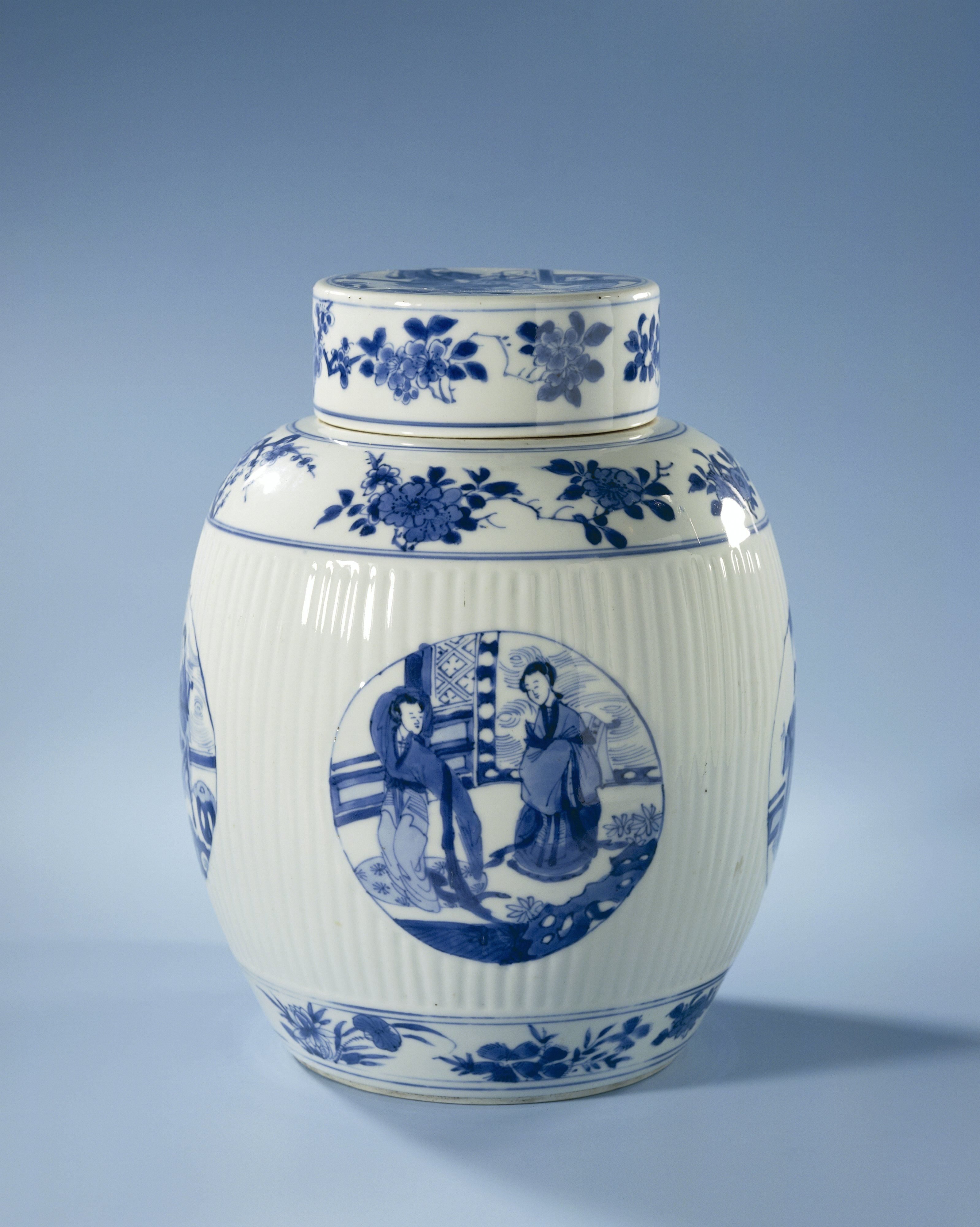 Ovoid covered jar with fluted sides and figures in medallions