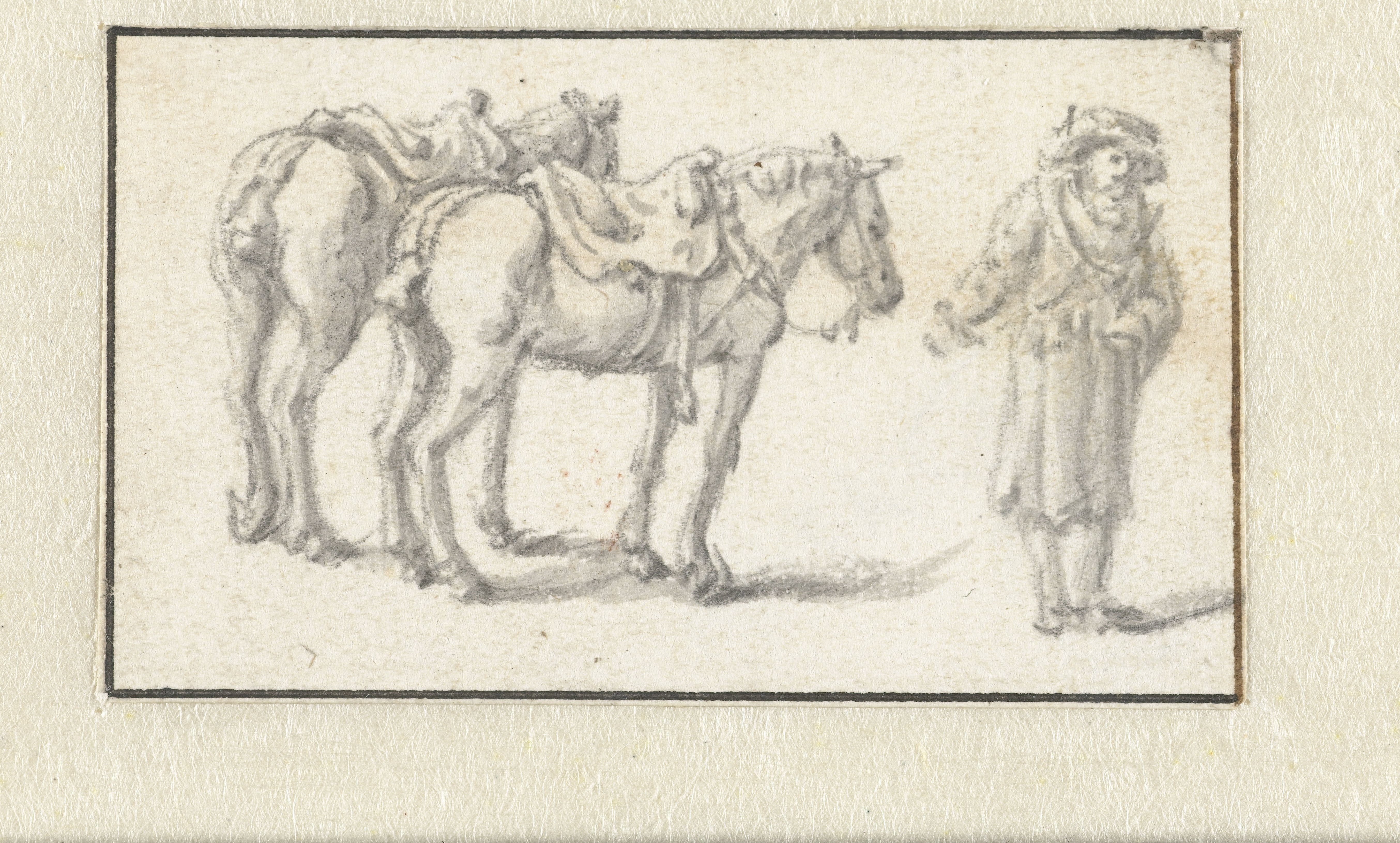 Man staand naast twee paarden