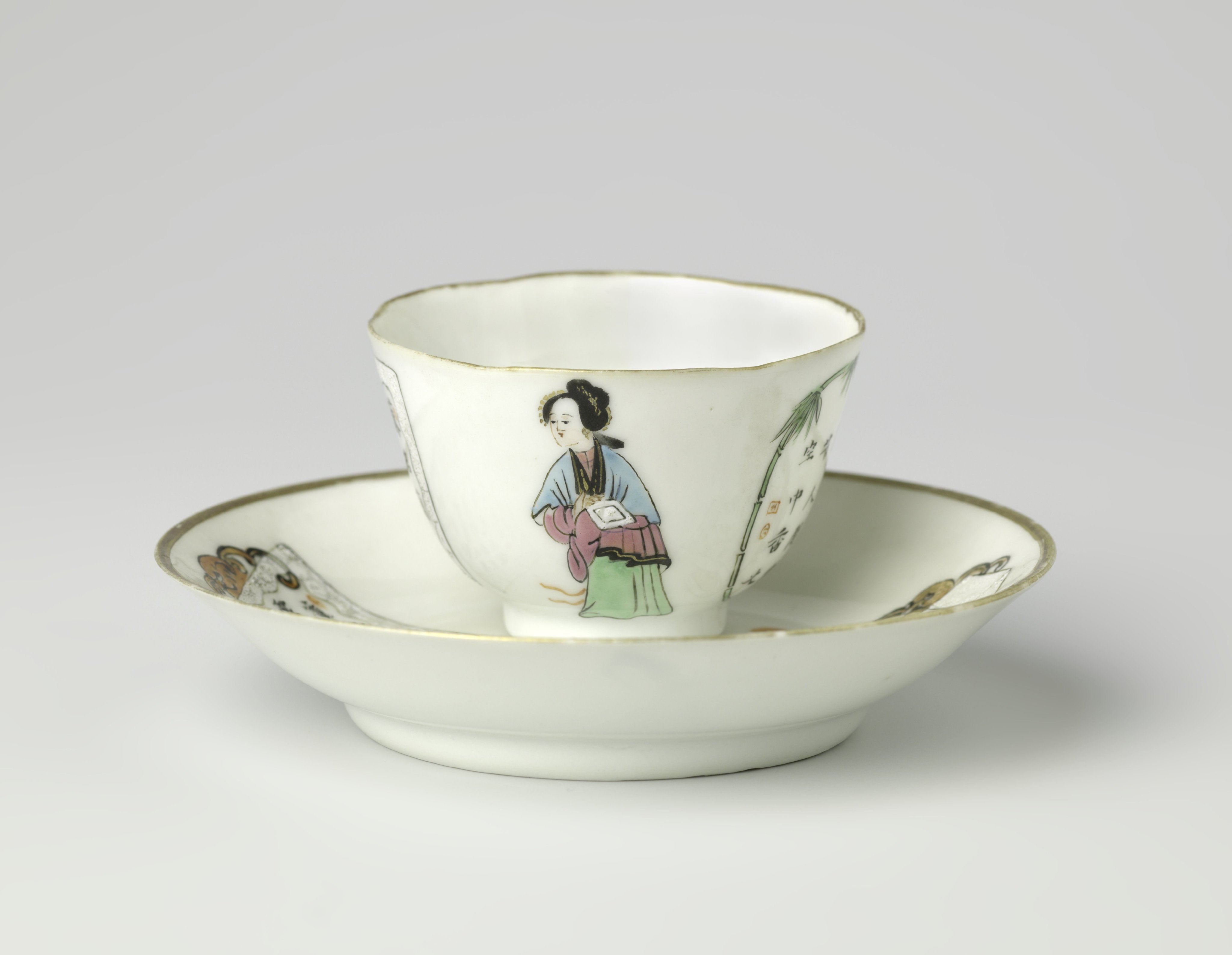 Cup and saucer with a man, woman and two panels with characters