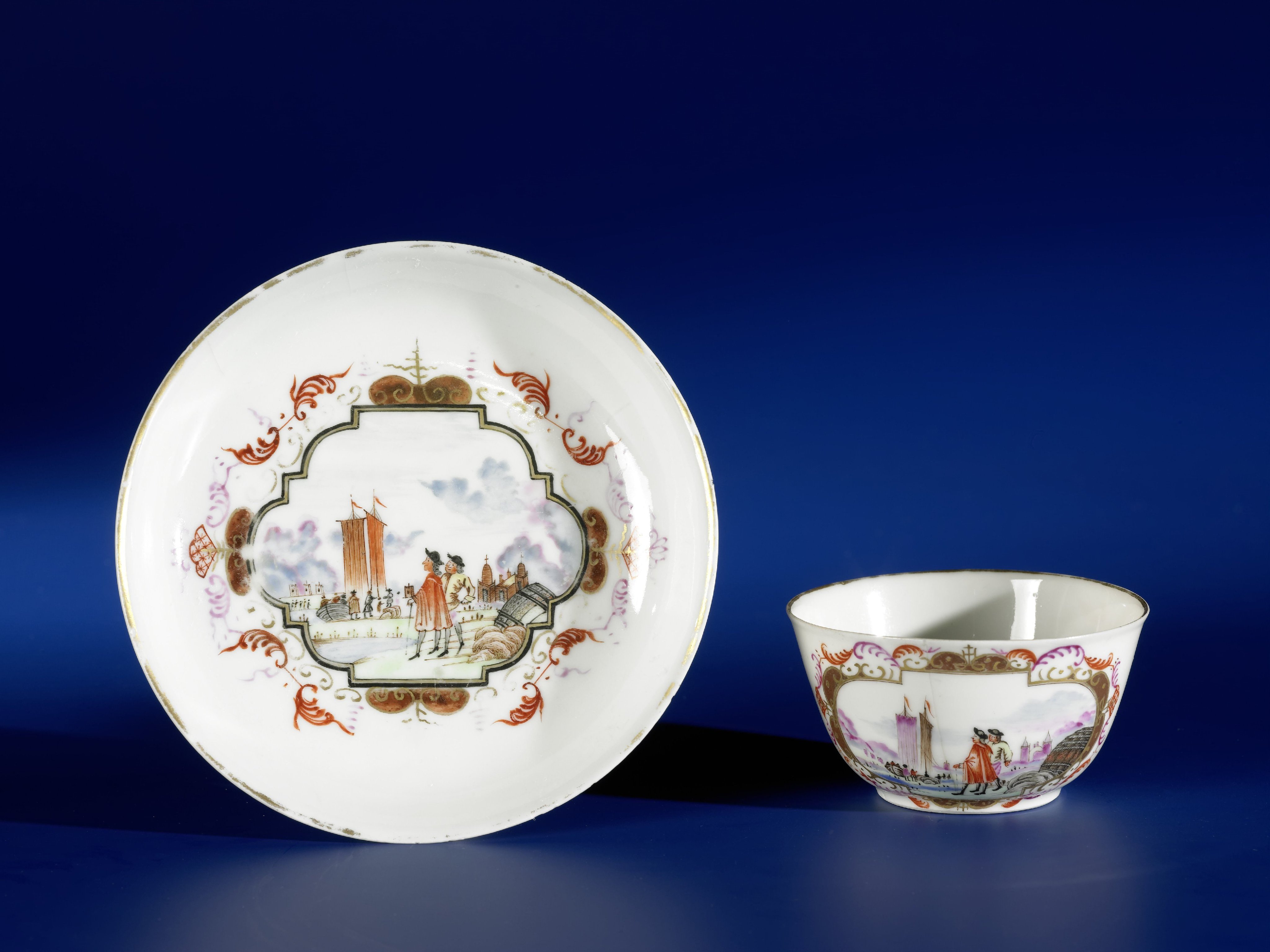 Bell-shaped cup and saucer with two European men at different seaports