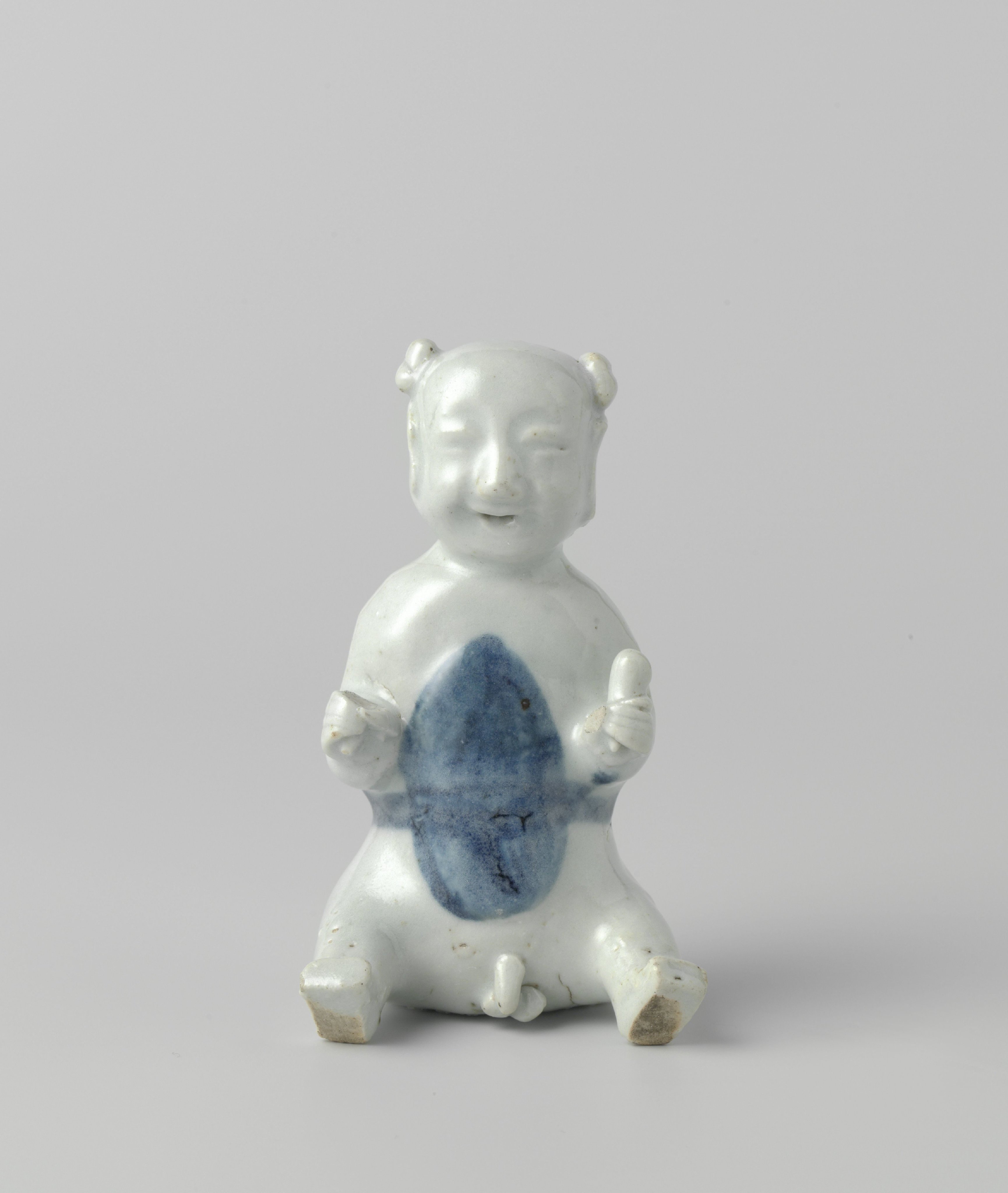 Figure of a seated boy