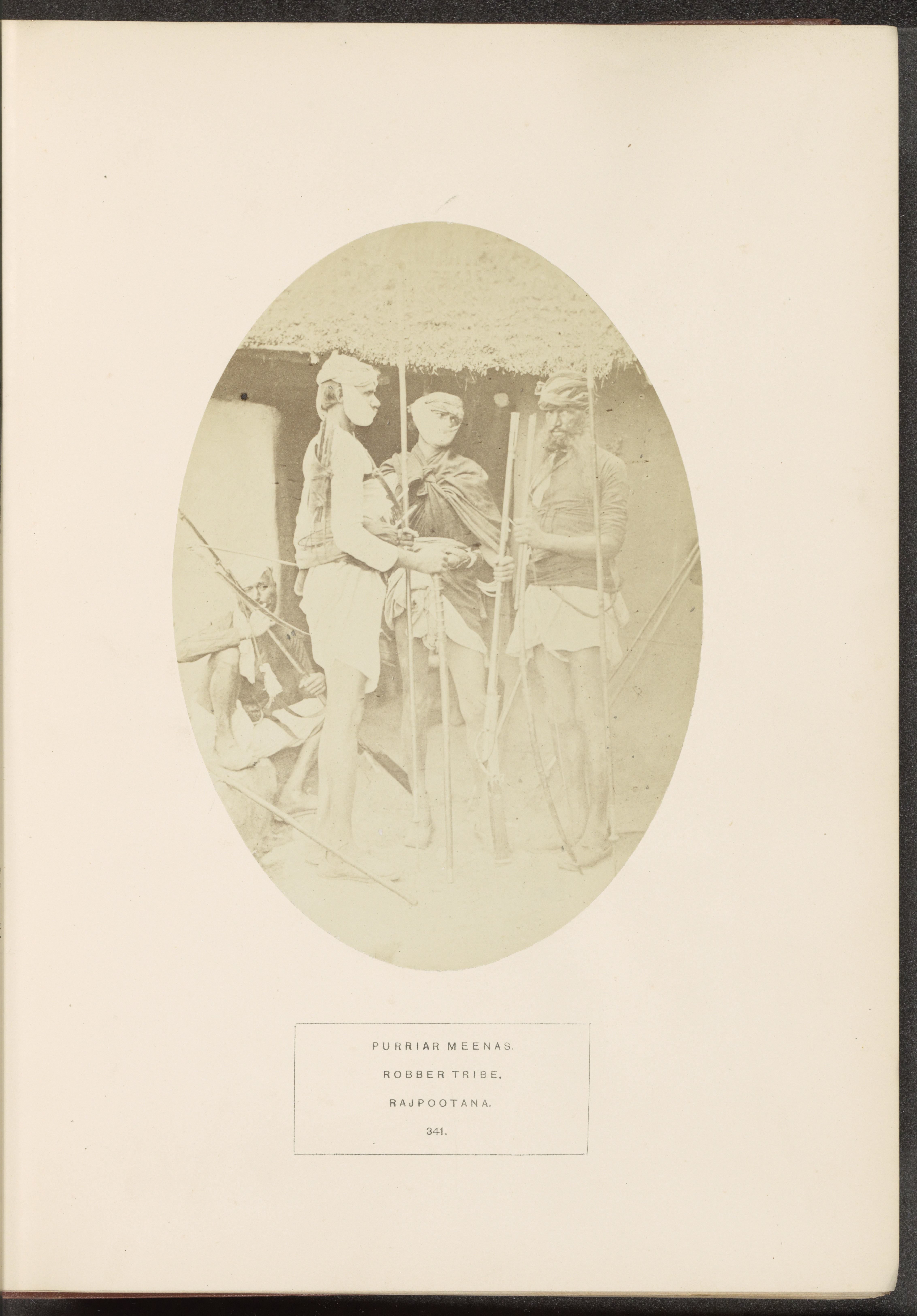 Portrait of four unknown men from the Meena tribe with weapons, Rajasthan, India