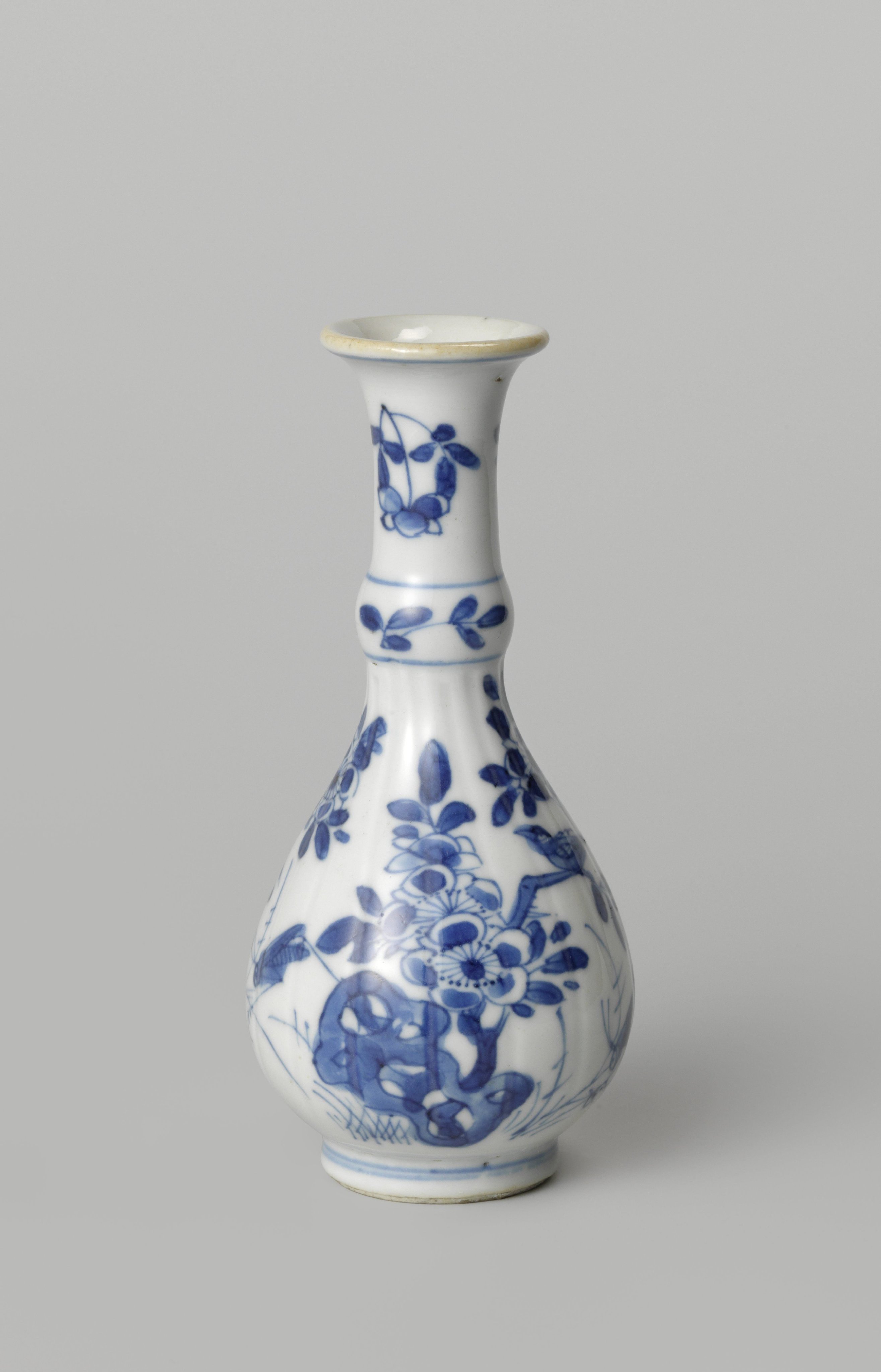 Pear-shaped bottle vase with flowering plants, birds and insects near a rock