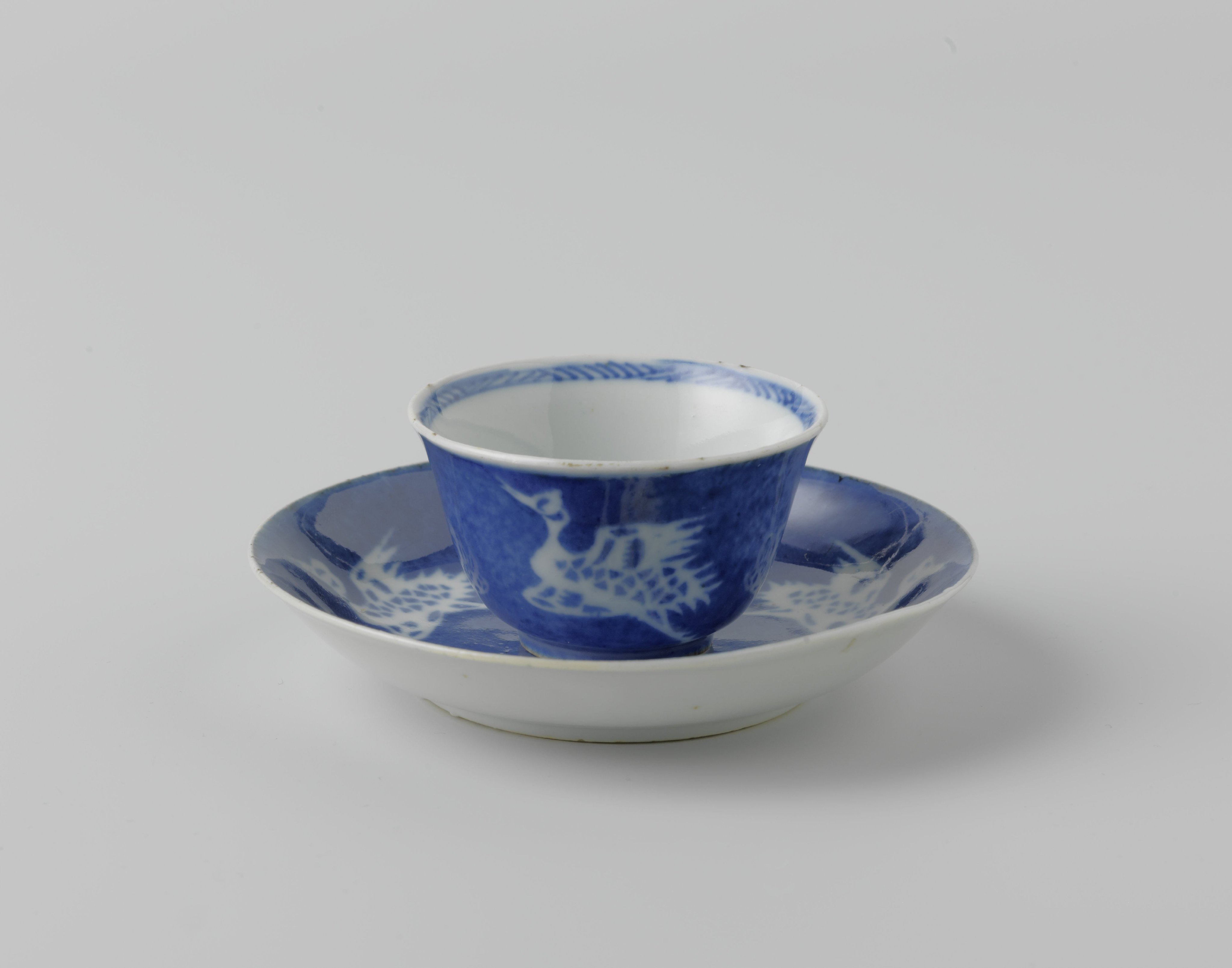 Cup and saucer with powder blue and cranes