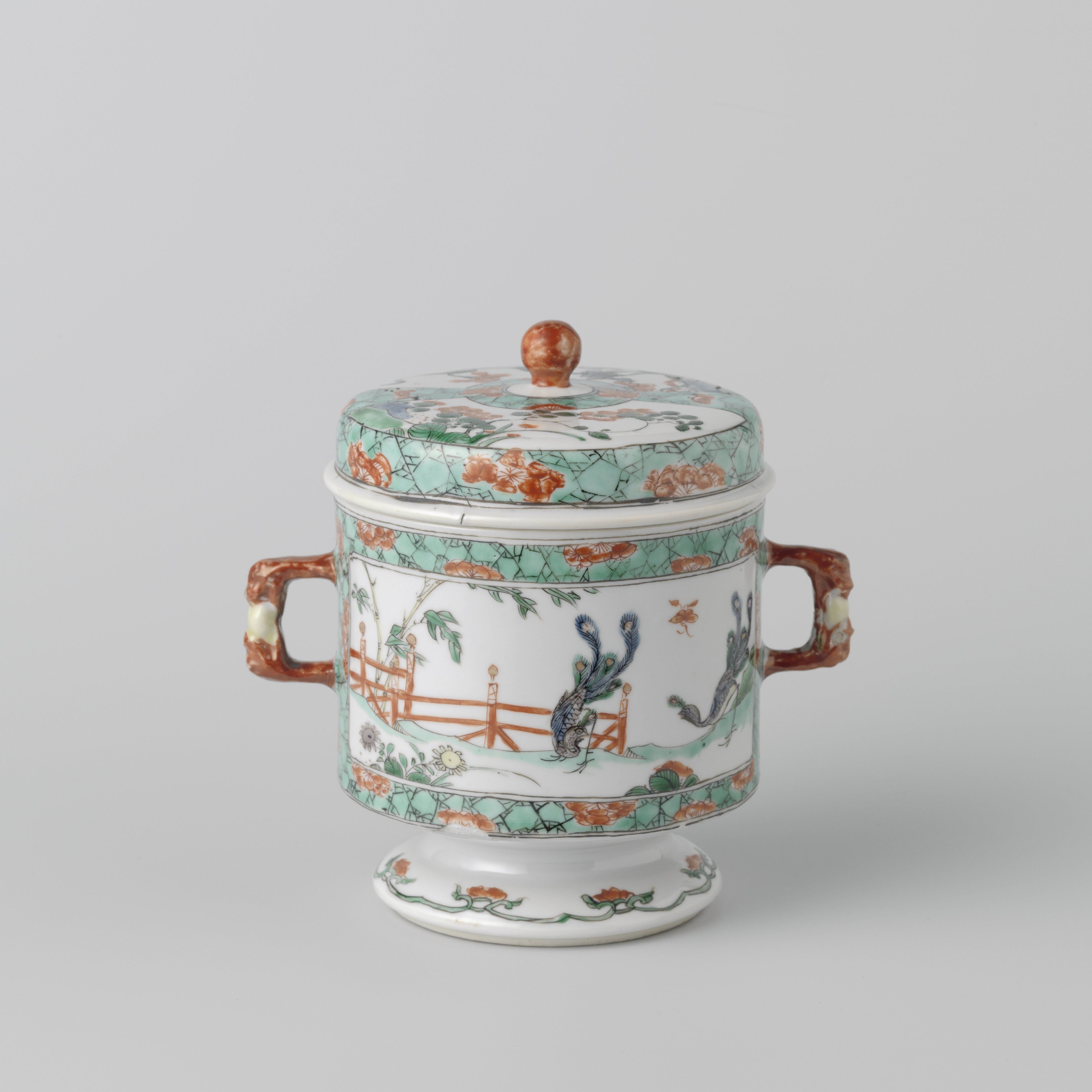 Covered jar with peacocks and flowering plants in a fenced garden