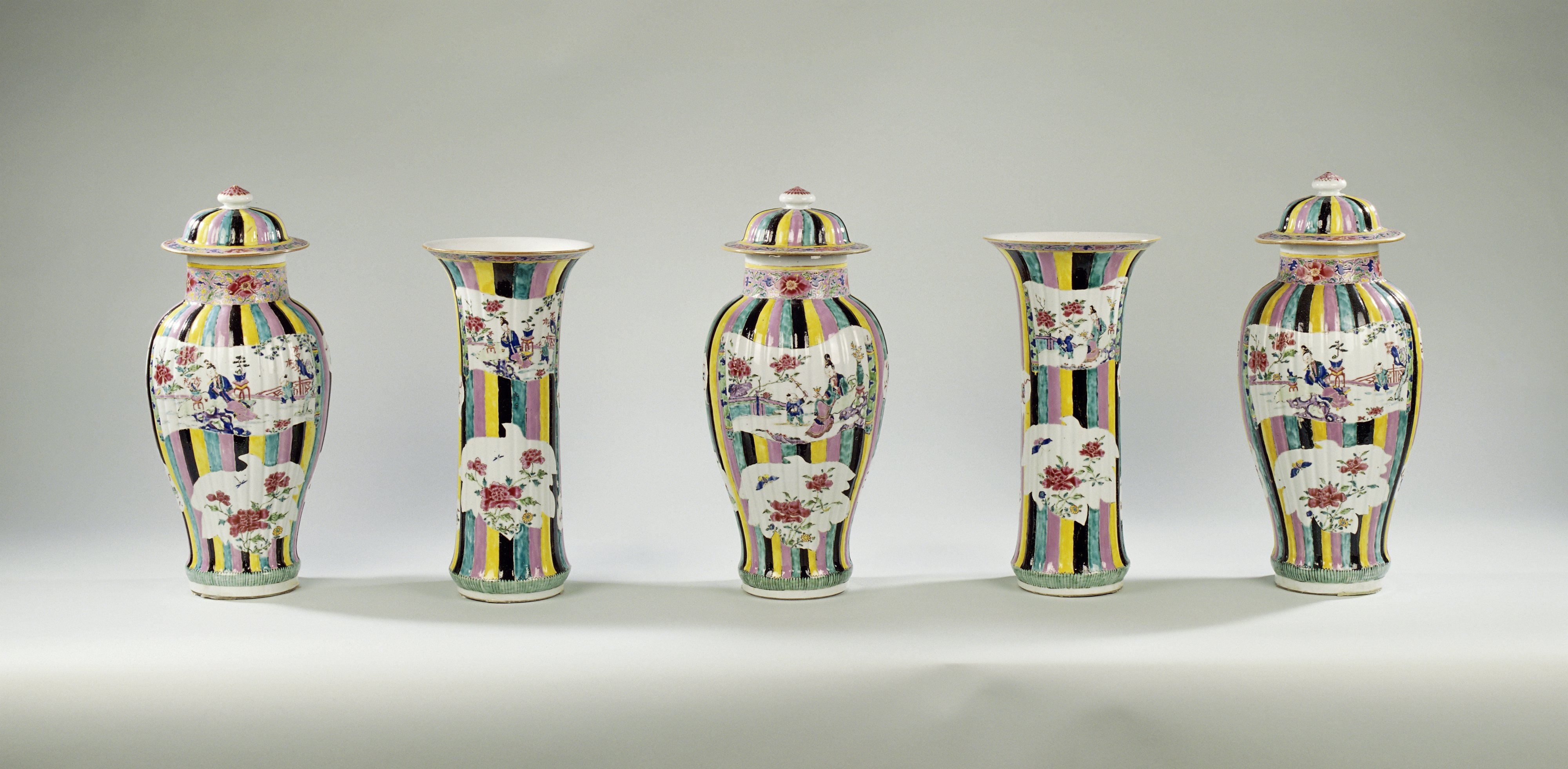 Garniture with figures, flower sprays and auspicious symbols in shaped panels on a multi-colored ground