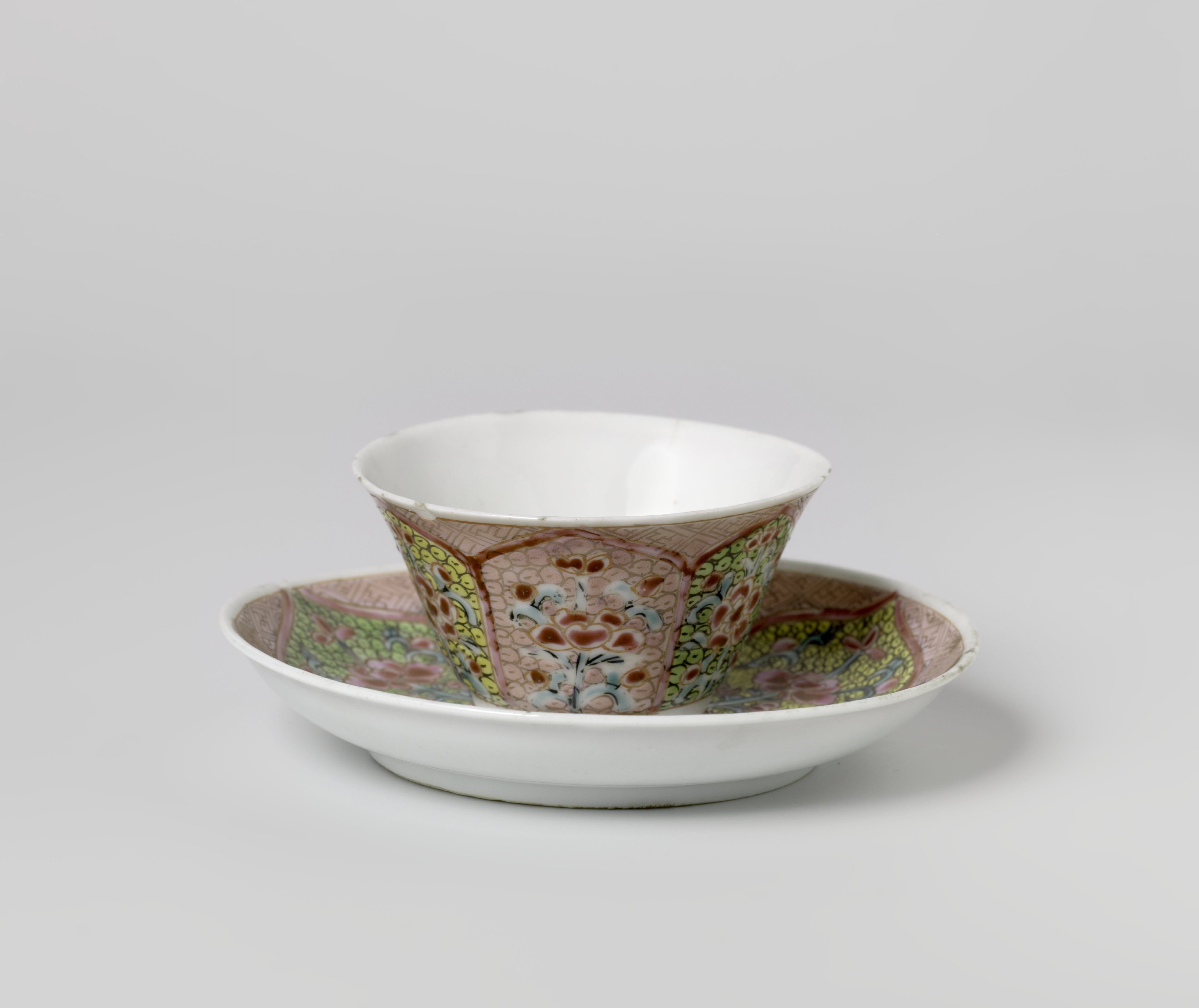 Cup and saucer with floral scrolls in petal-shaped panels