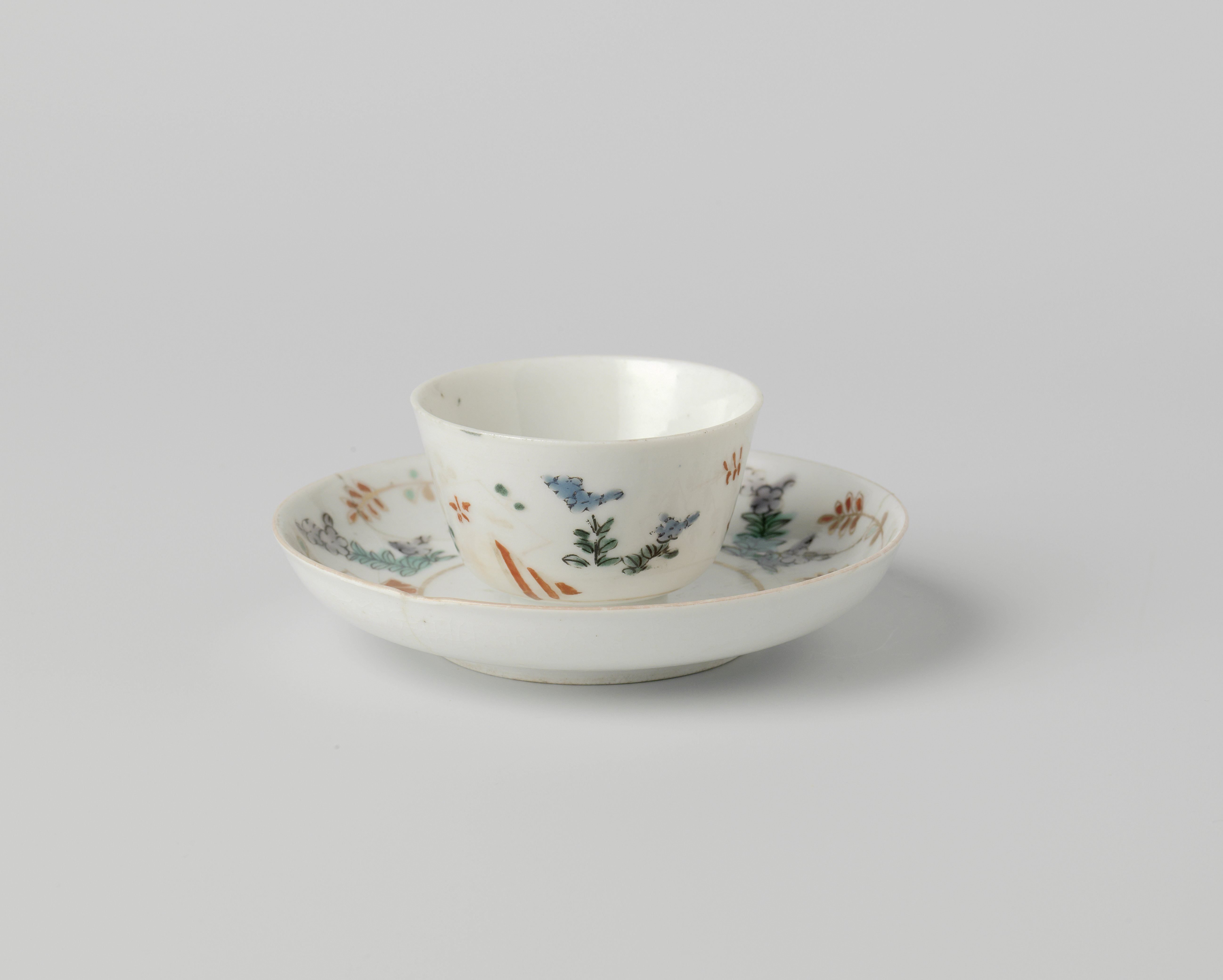 Cup and saucer with lozenges and flowering plants