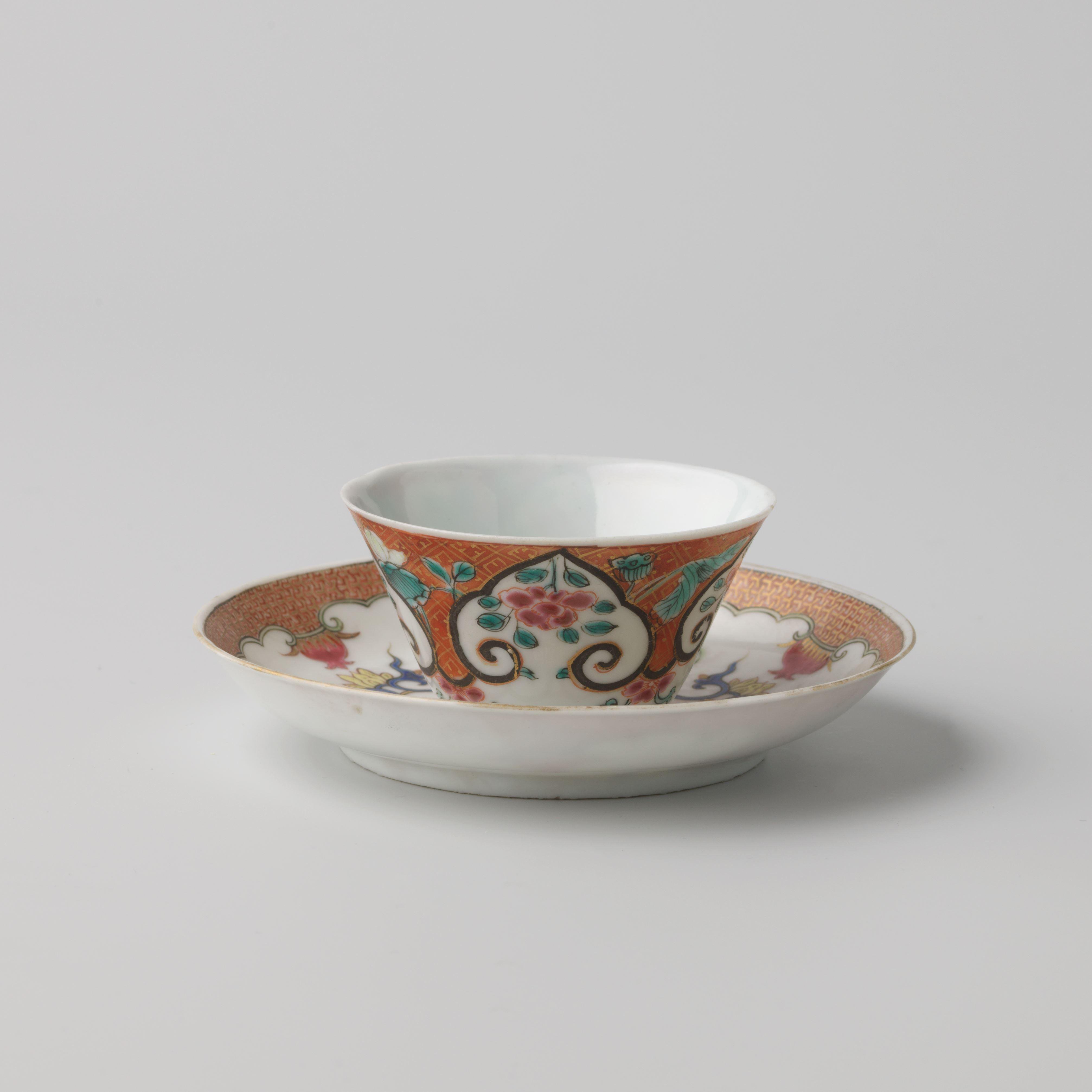 Cup and saucer with flower sprays and flowering plants on a diaper-pattern