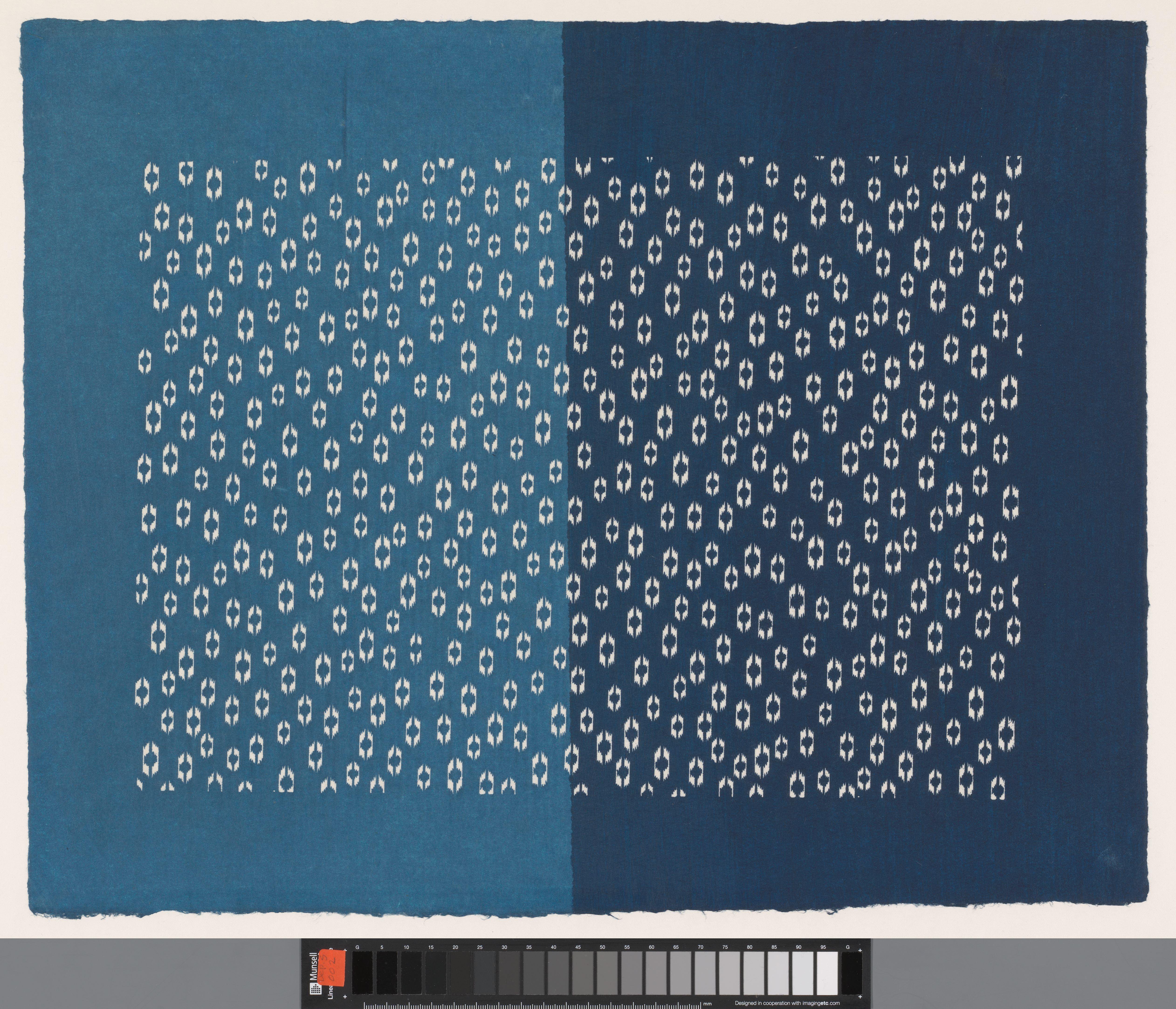 Blad met licht- en donkerblauwe helften met uitgespaard hexagonaal motief