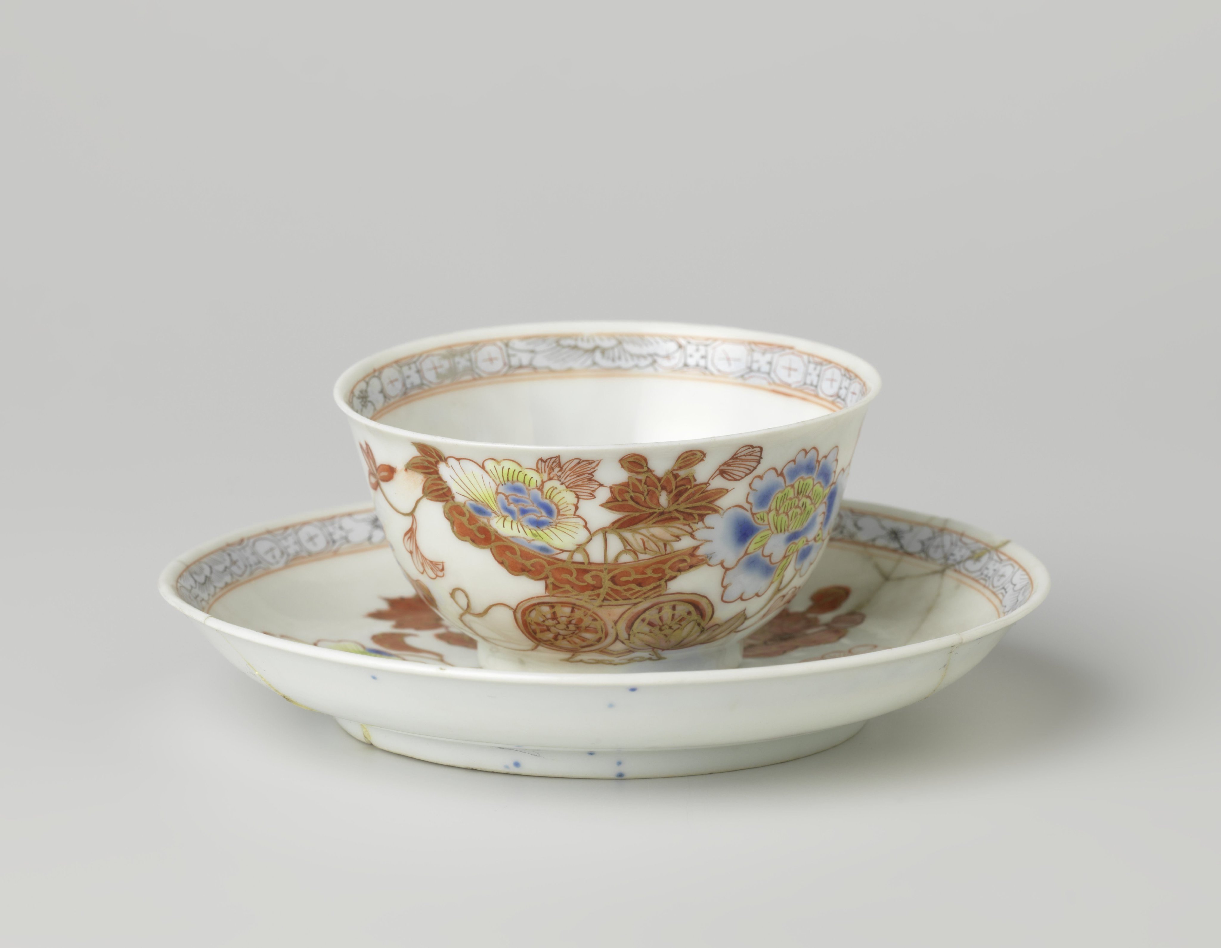 Bell-shaped cup and saucer with a flower basket