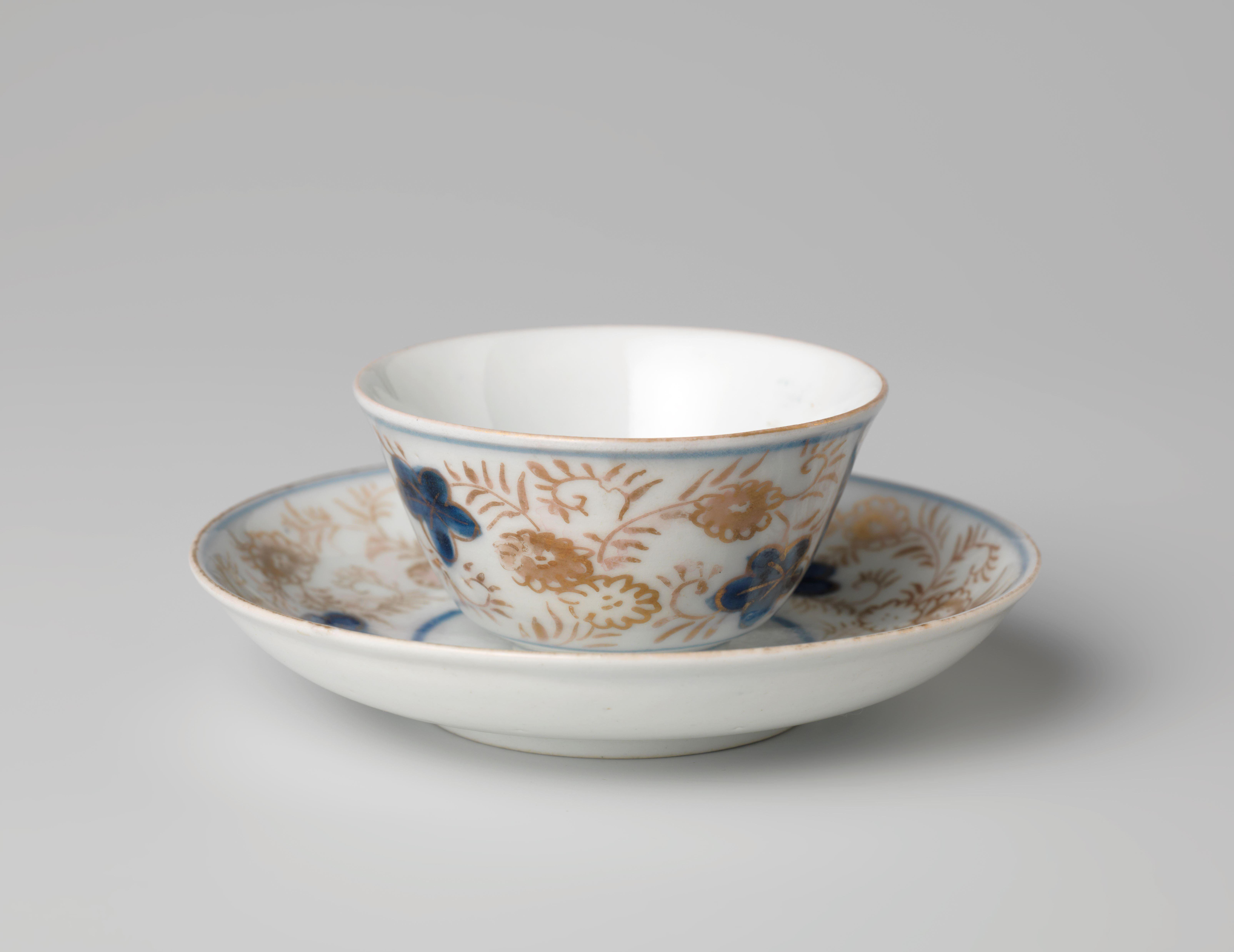 Bell-shaped cup and saucer with a flower basket and floral scrolls