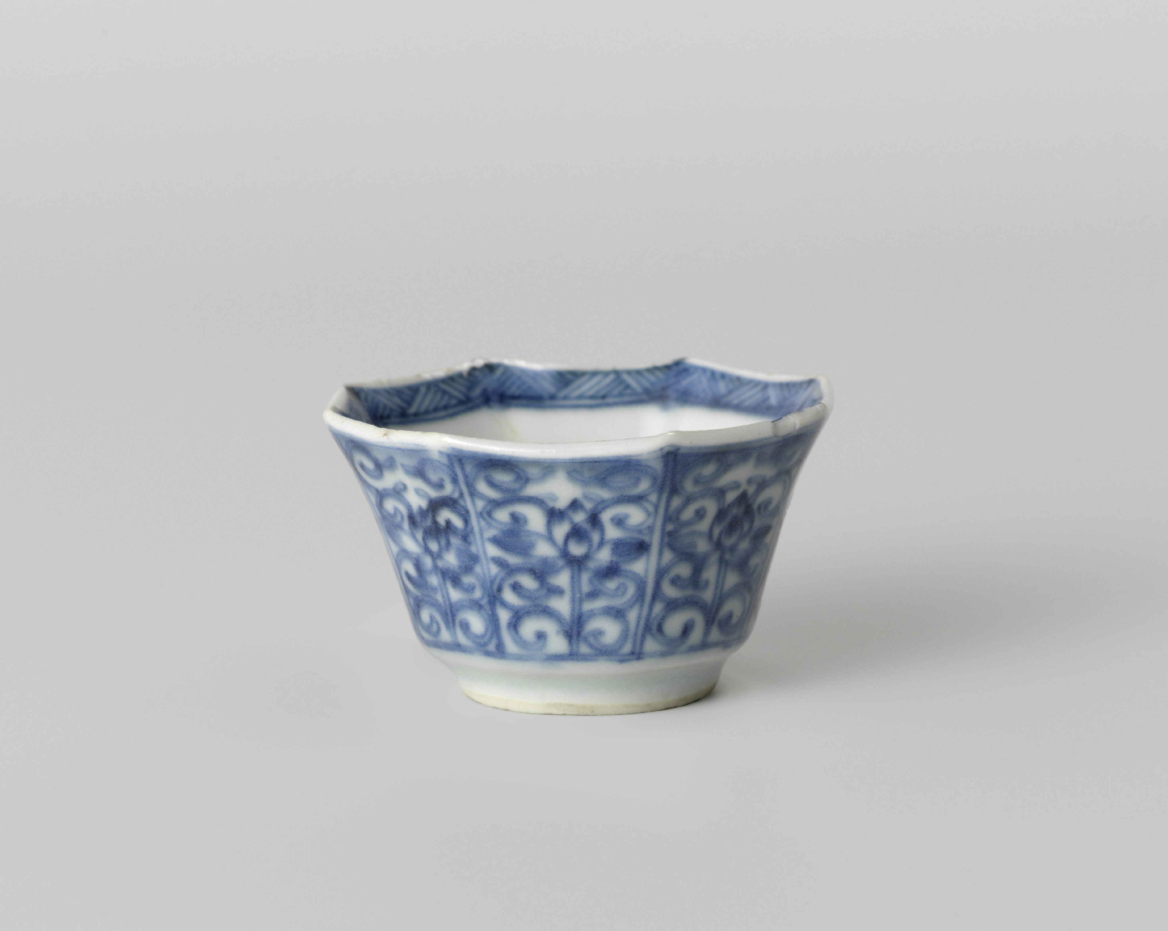 Octagonal cup with flower scrolls in panel decoration
