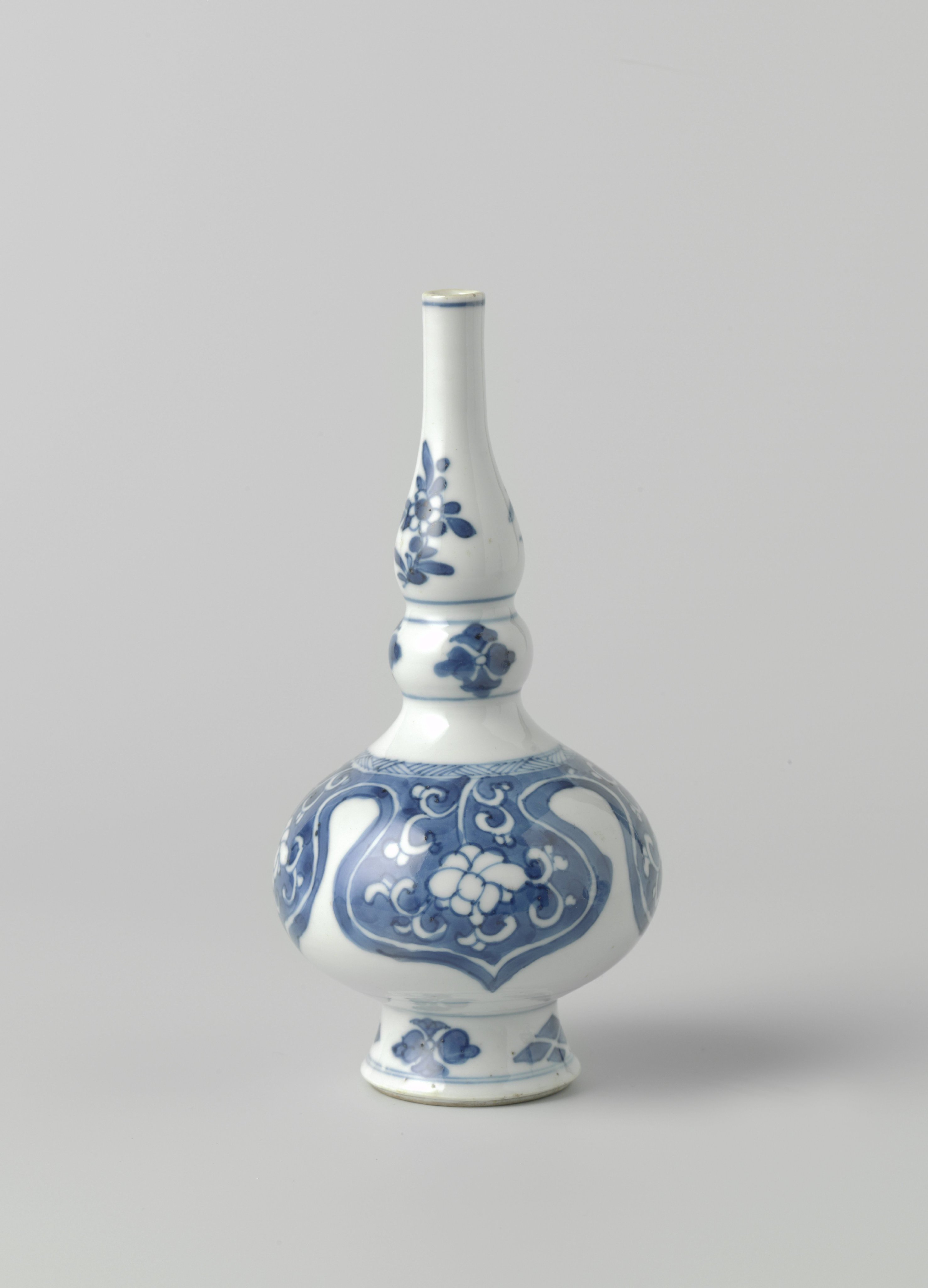 Rosewater sprinkler or bottle vase with  floral scrolls in reserve in lambrequins