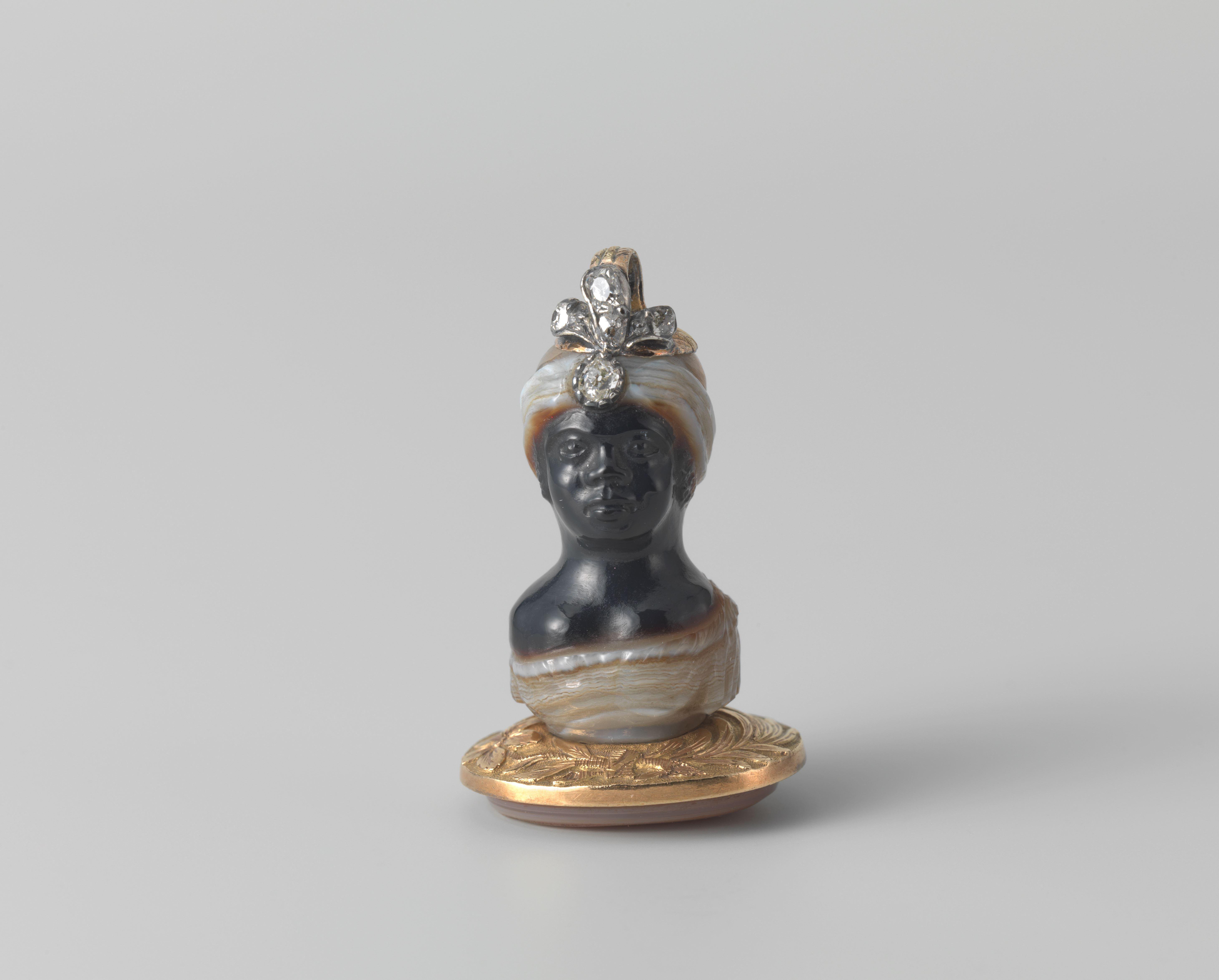 Seal shaped as a Buste of an African Man with carved intaglio carnelian base showing a male portrait en profil.