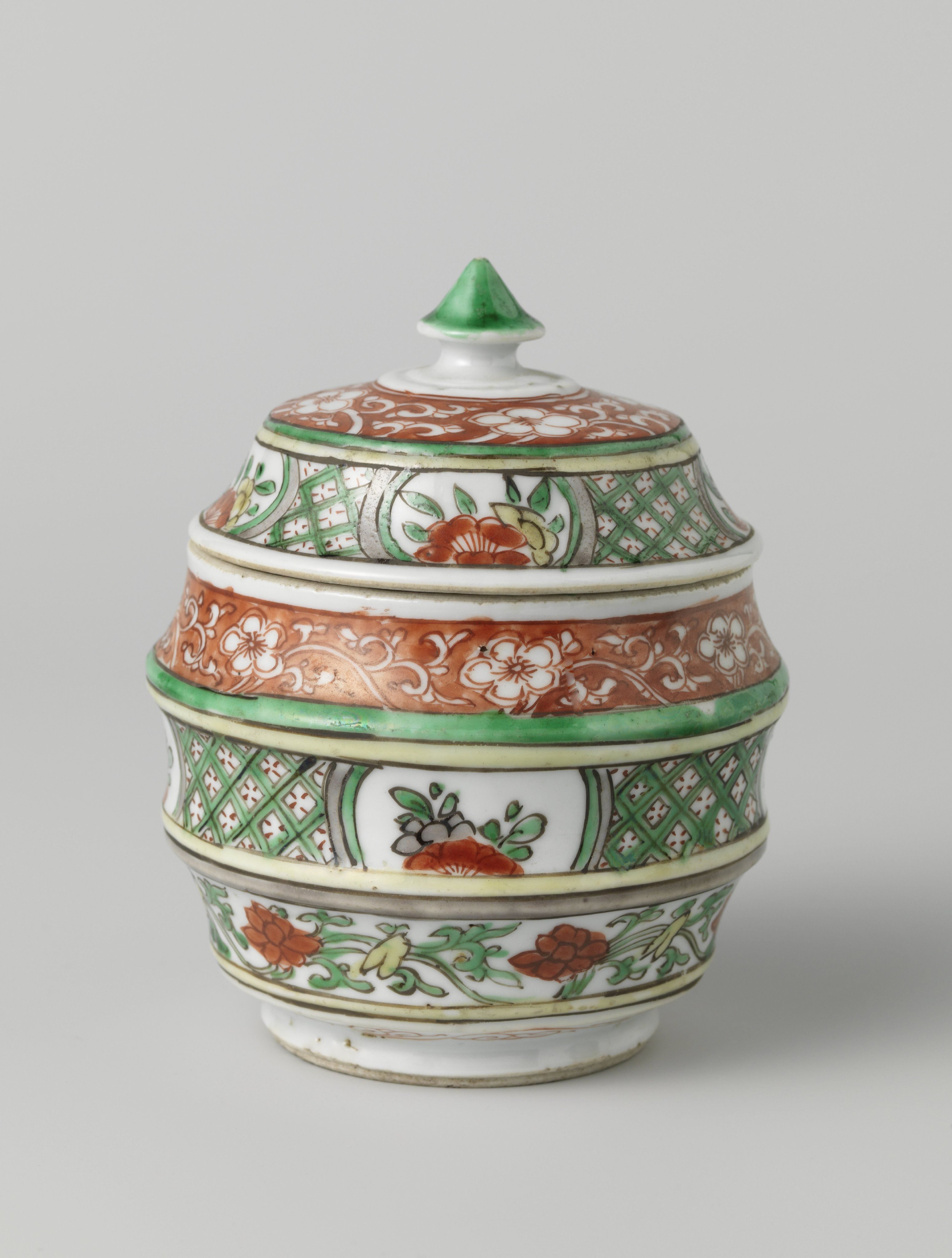 Barrel-shaped covered jar with flower scrolls and geometric patterns