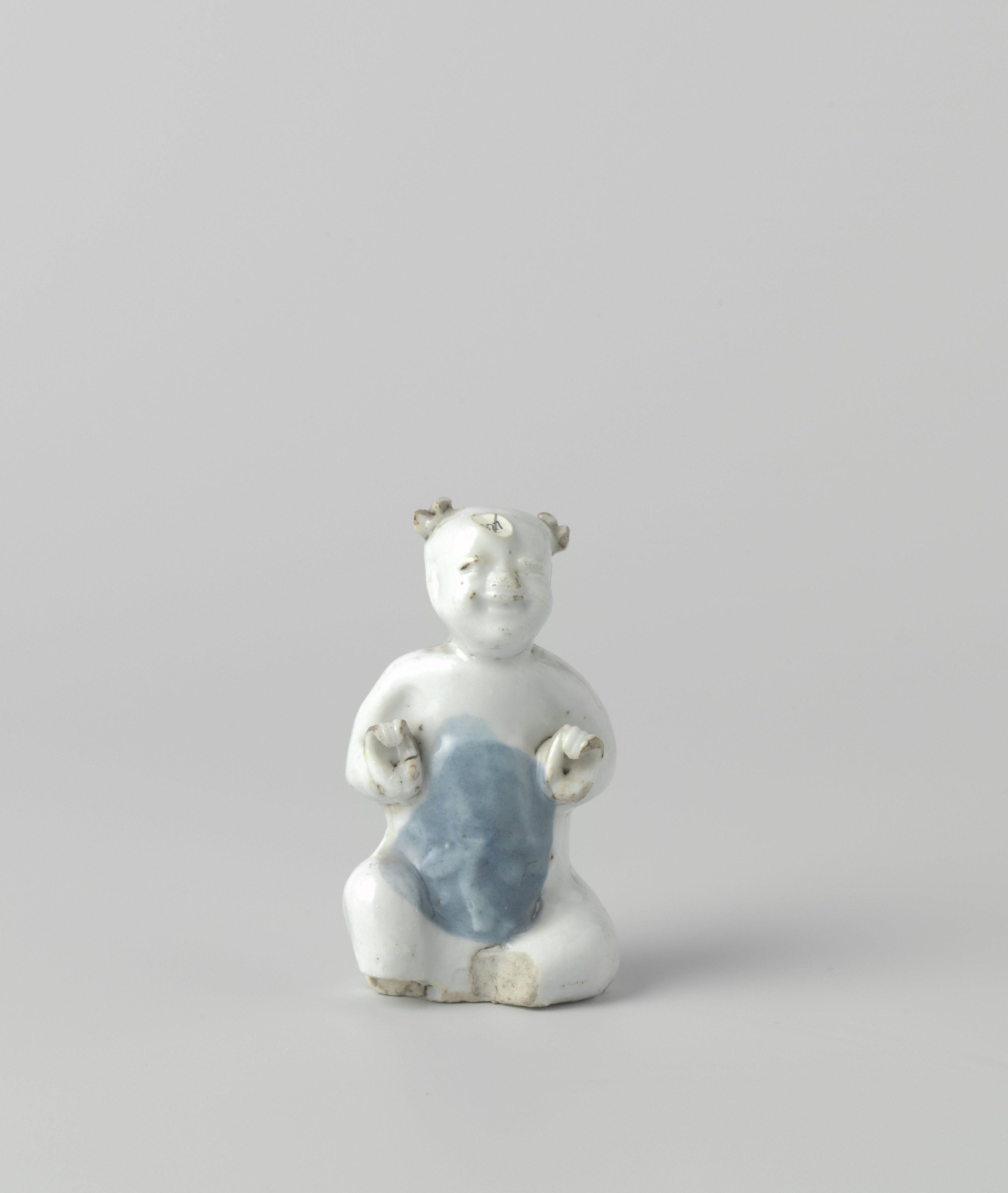Figure of a seated boy