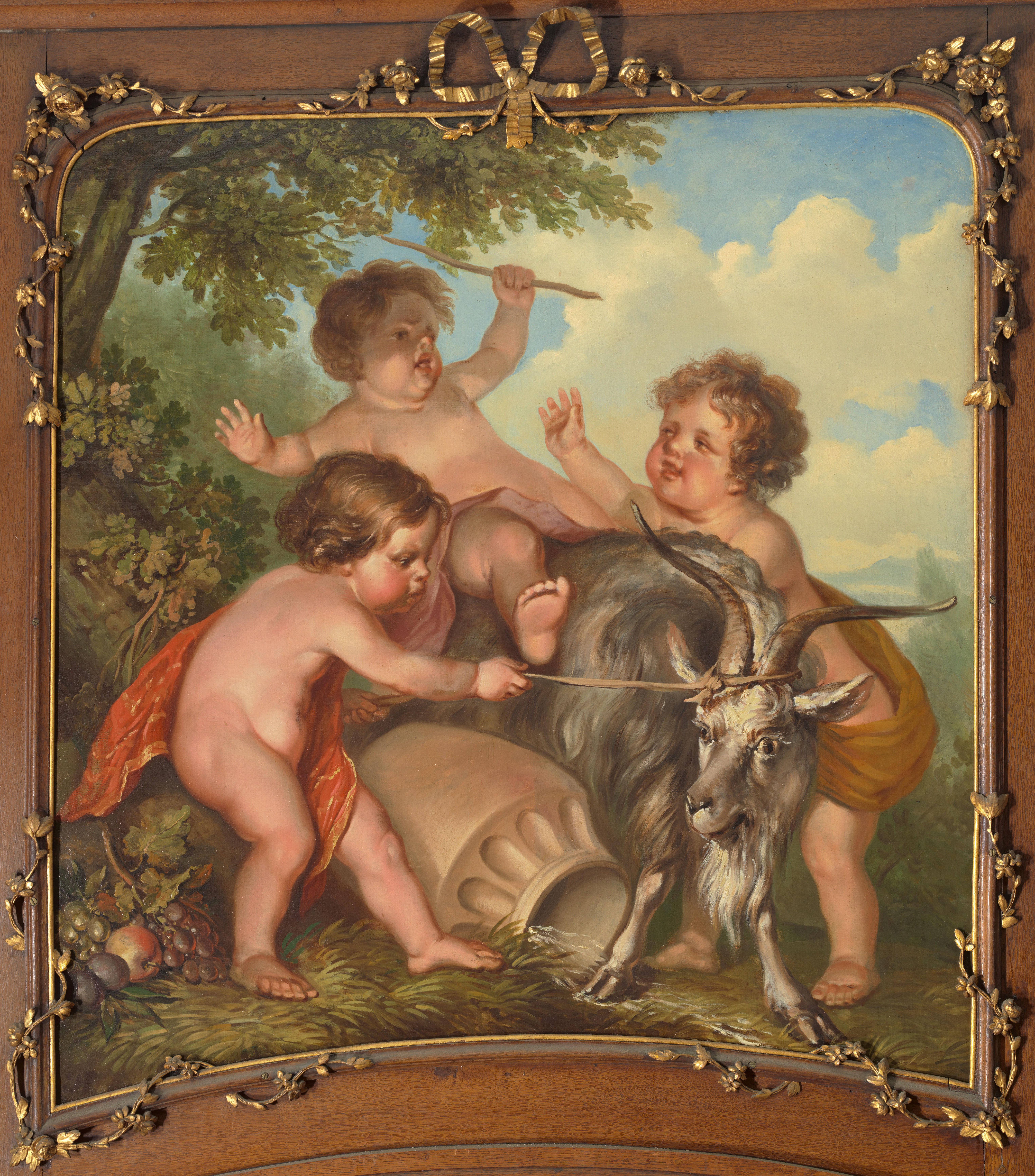 Drie kinderen spelend met een bok